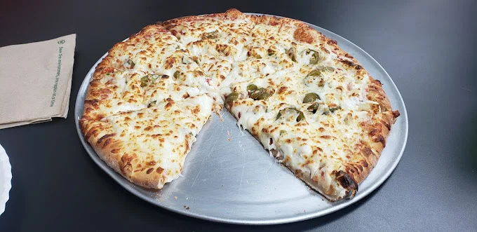 Cheesy jalapeño pizza on a metal tray