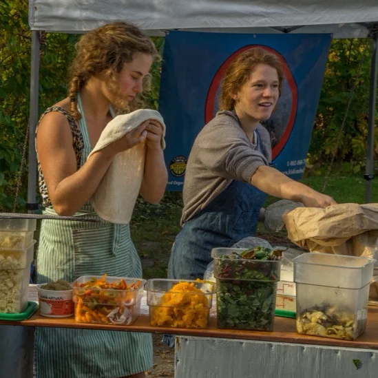 Chef preparing a traditional dish outdoors in a scenic setting