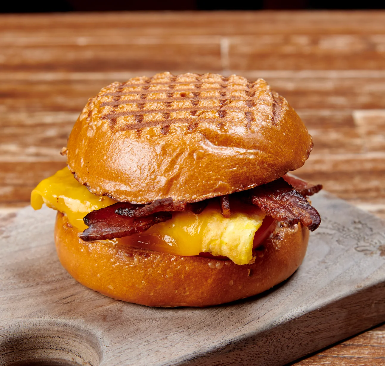Breakfast sandwich with bacon and cheese on a toasted bun