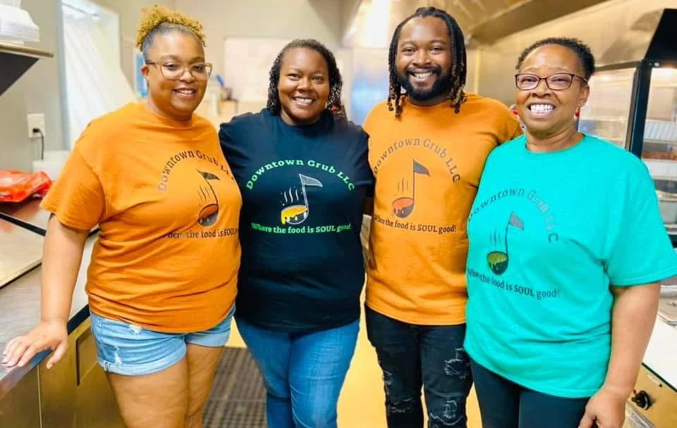 Team members of Downtown Grub LLC in colorful shirts