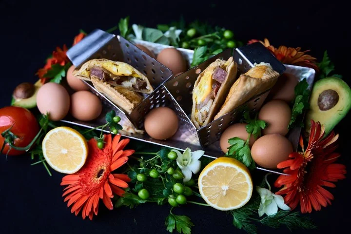 Savory empanadas served with fresh herbs and eggs