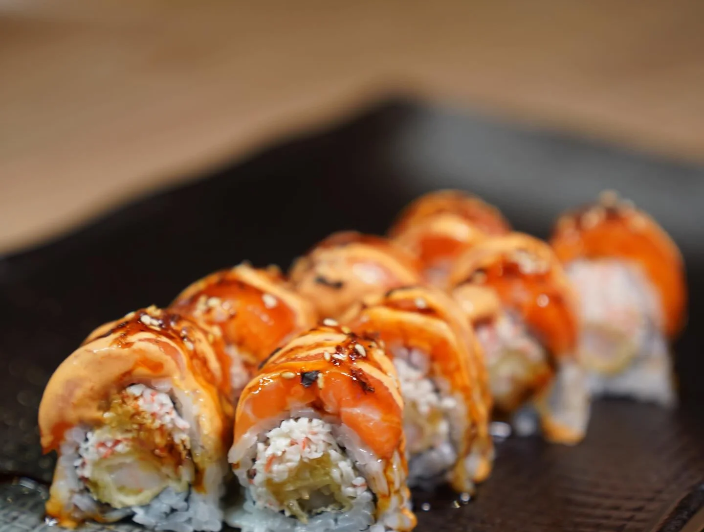 Japanese sushi rolls with grilled salmon and eel sauce