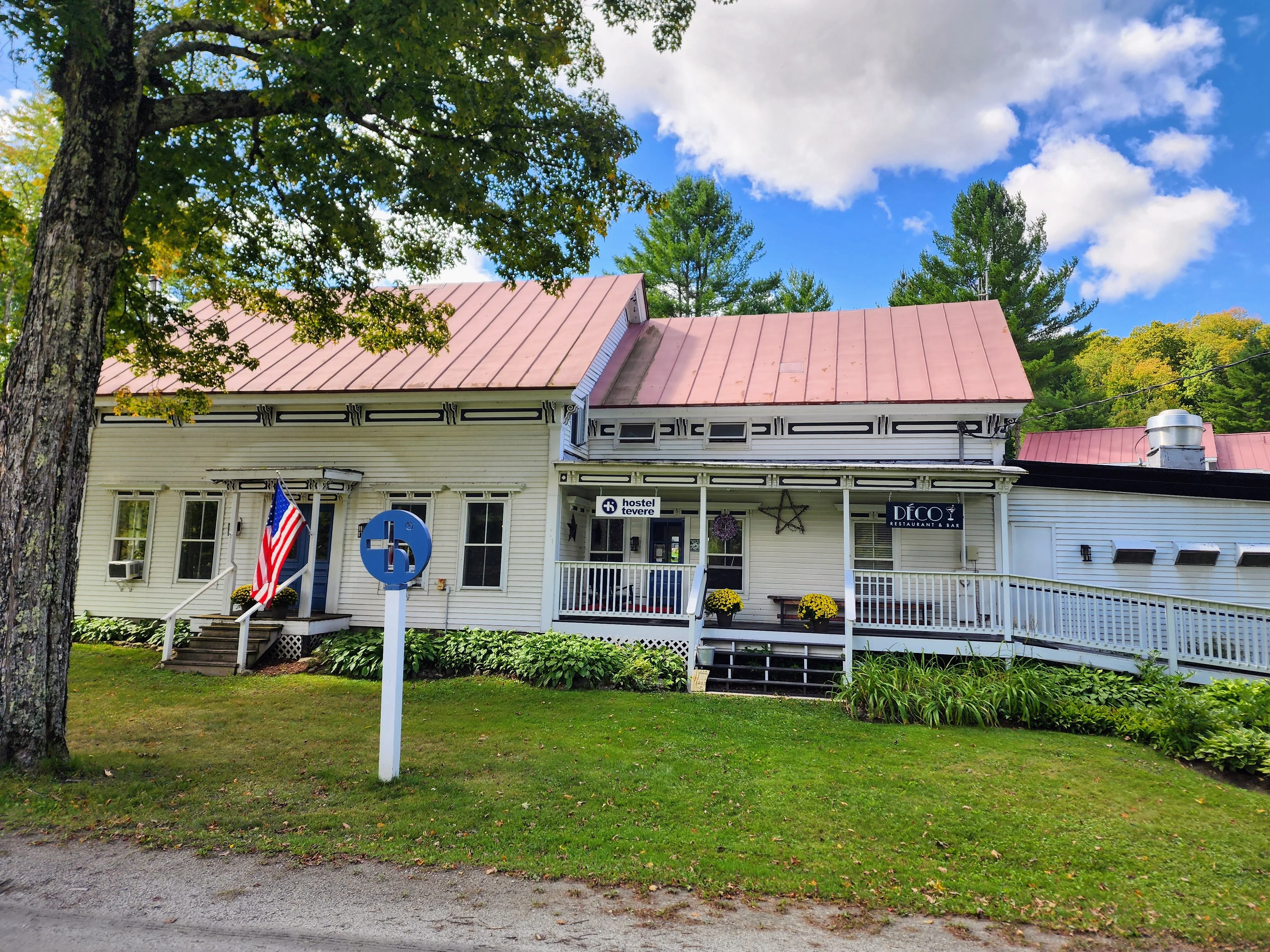 Charming restaurant exterior with American flag and welcoming porch