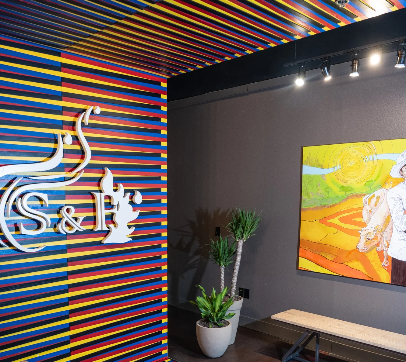 Vibrant restaurant interior with colorful striped walls and artwork