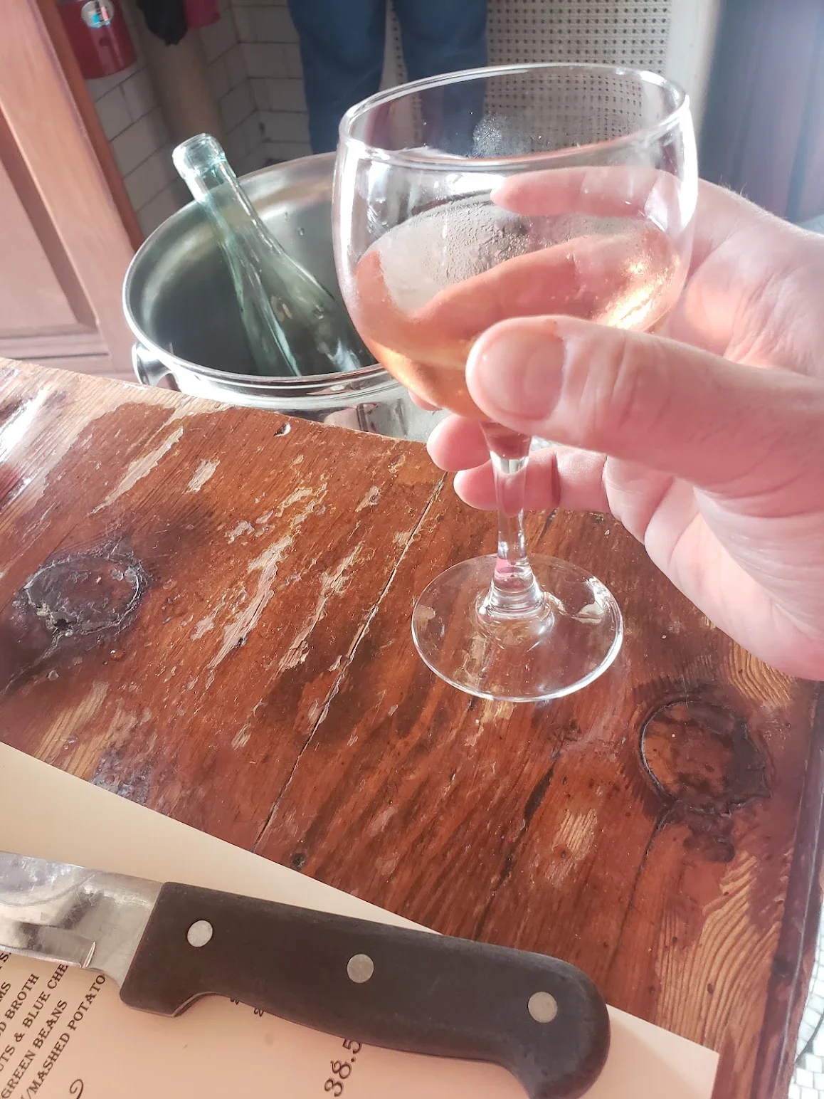 Refreshing glass of rosé wine on a rustic wooden table