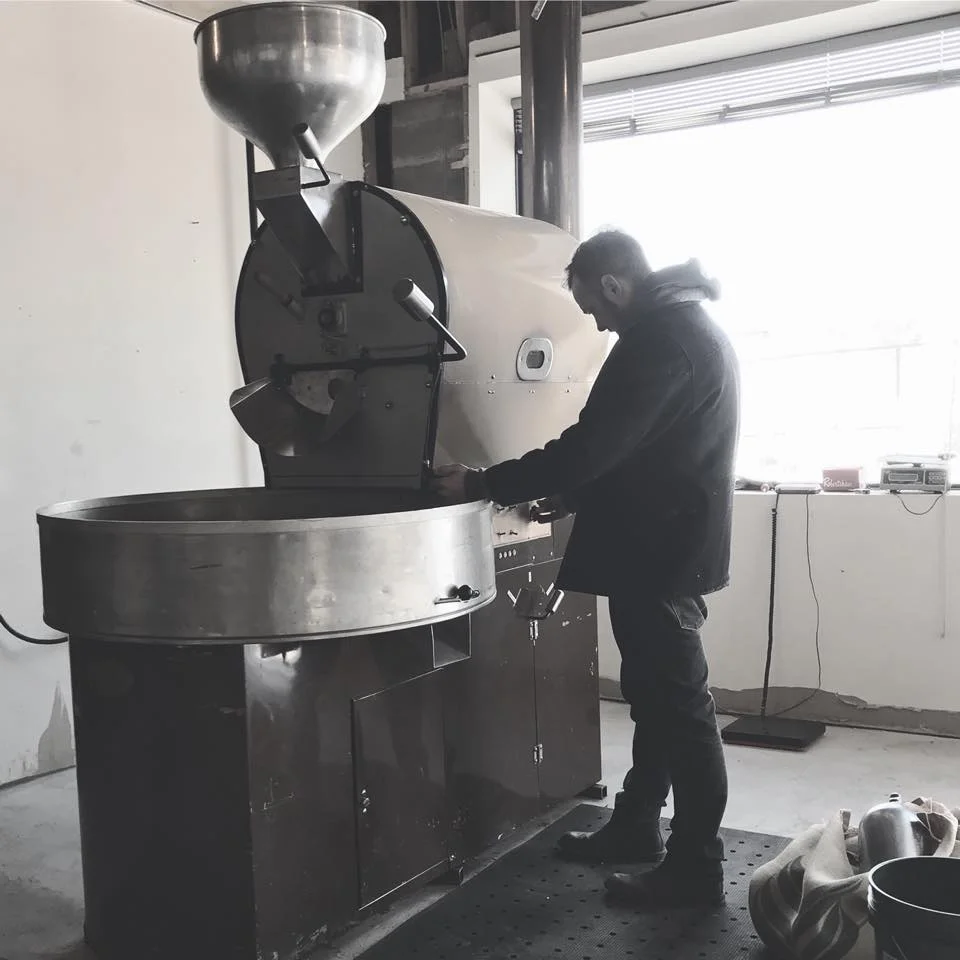 Coffee roaster in a modern workshop setting