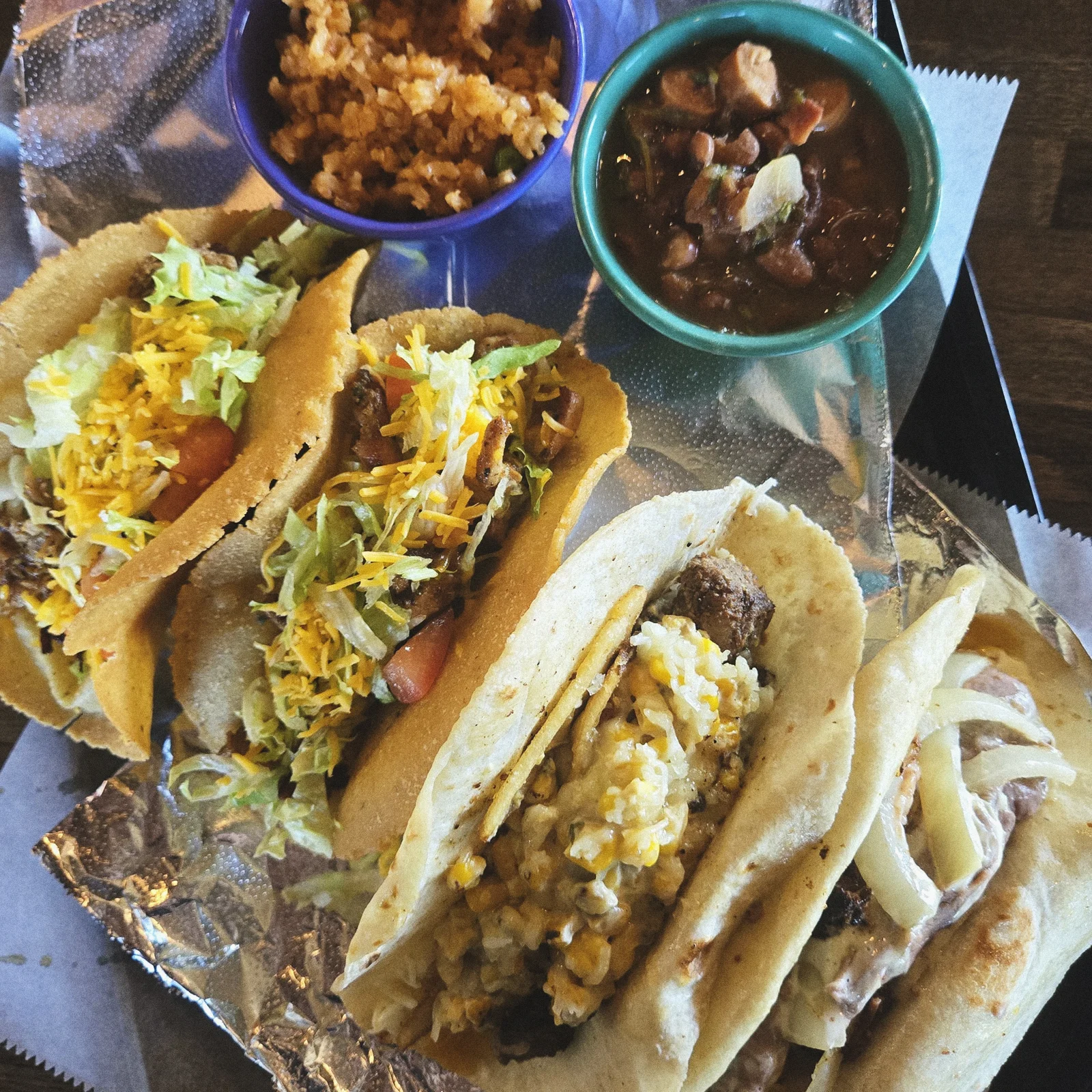 Assorted Mexican tacos with rice and beans