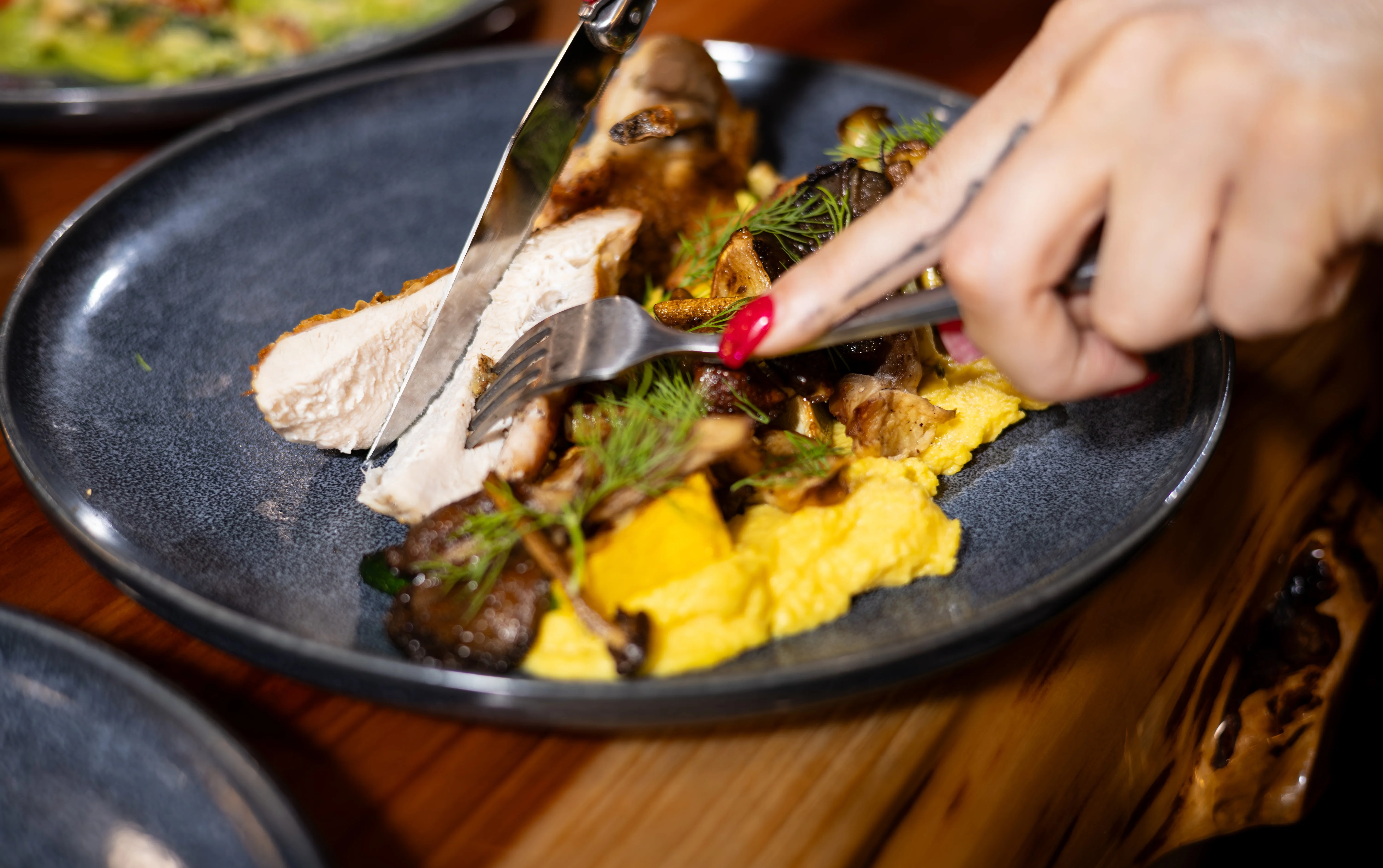 Plated chicken with polenta and sautéed vegetables