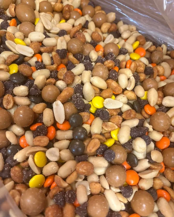 A colorful mixture of popcorn pieces in vibrant shades of pink, blue, green, and red, creating a festive appearance.