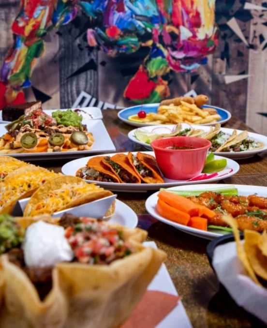 Colorful Mexican taco platter with sides