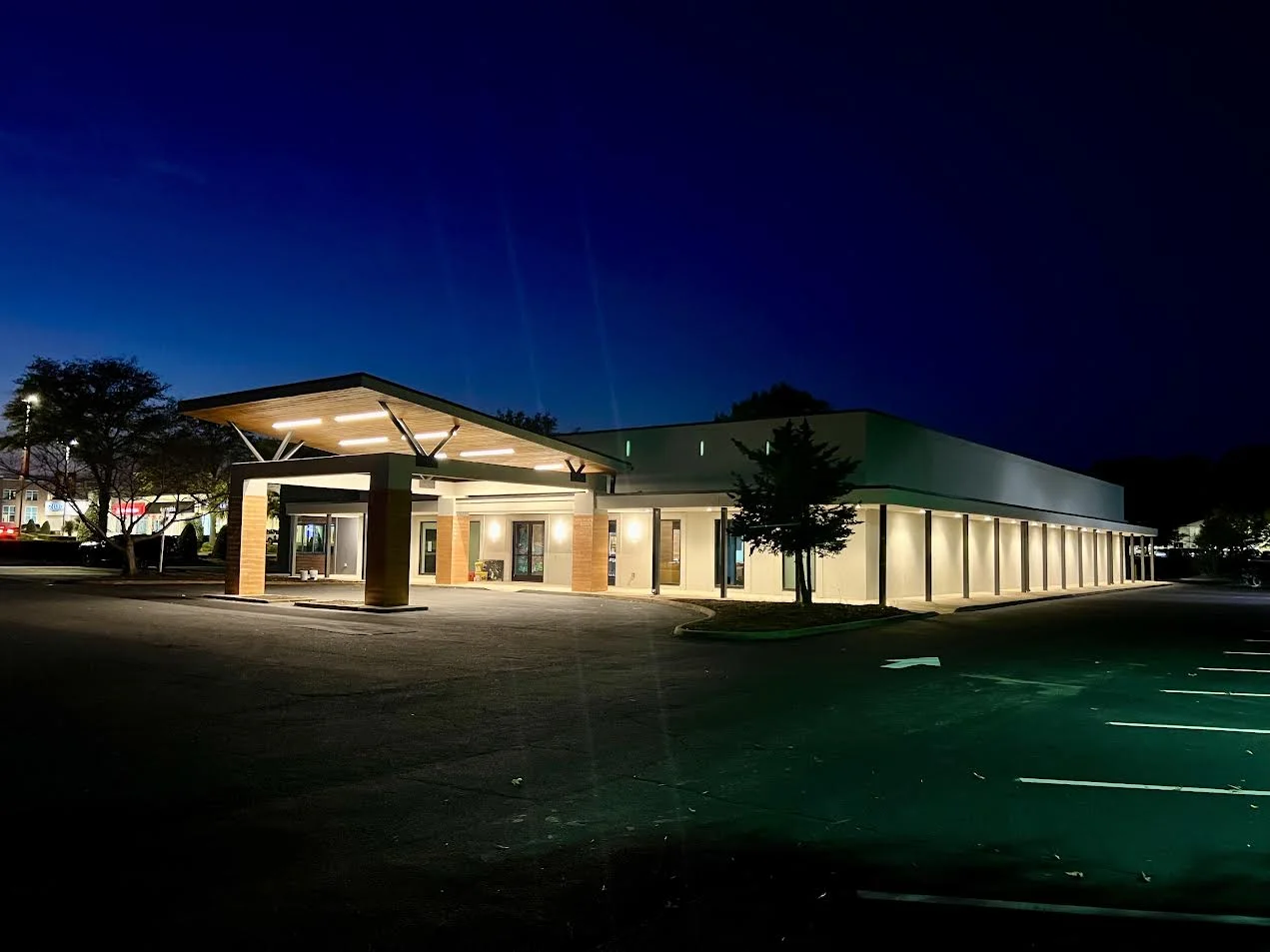 Modern restaurant exterior at night with illuminated entrance