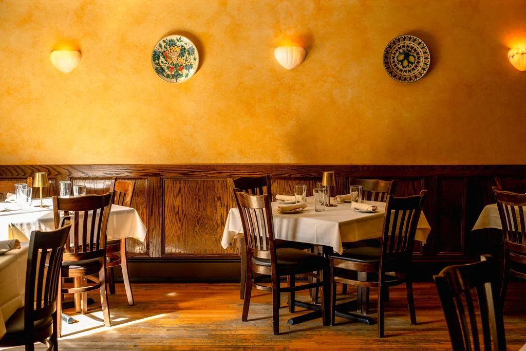 Cozy restaurant interior with warm yellow walls and wooden furniture
