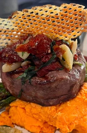 Grilled filet mignon with sweet potato puree and crispy garnish