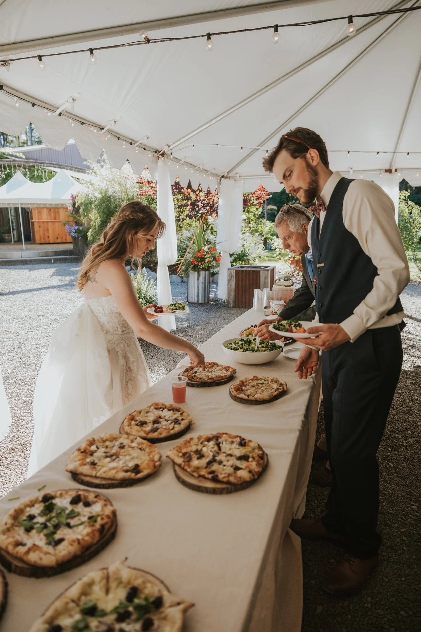 A bride picking out her pizza for her wedding