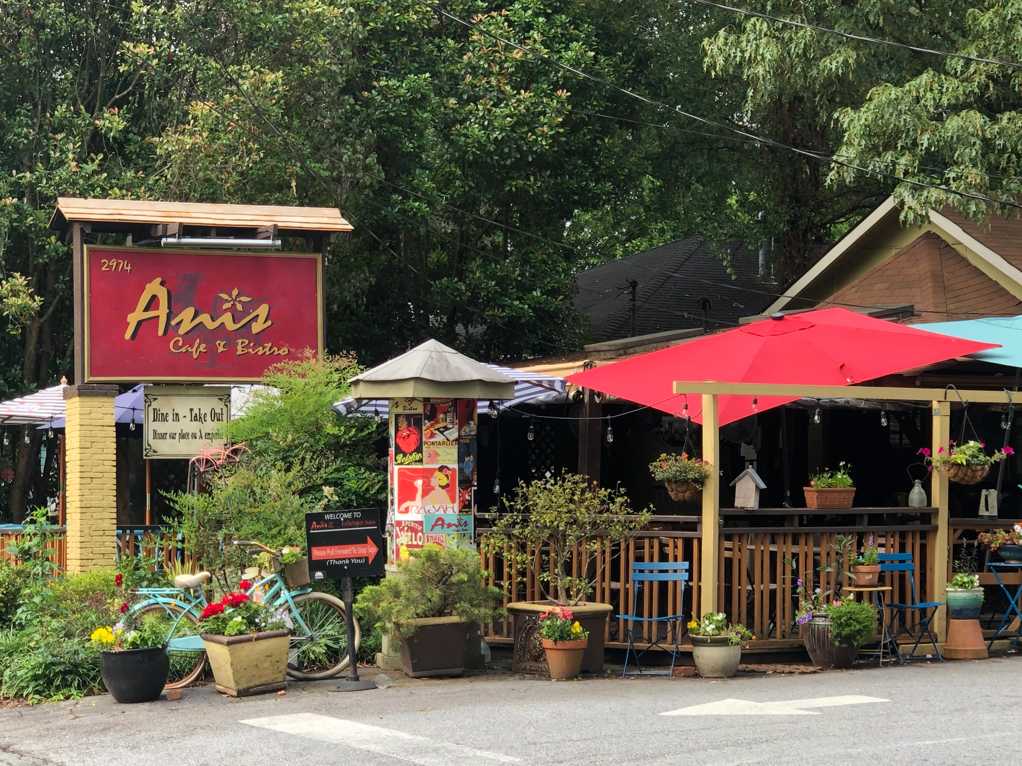 Charming café exterior with colorful umbrellas and plants