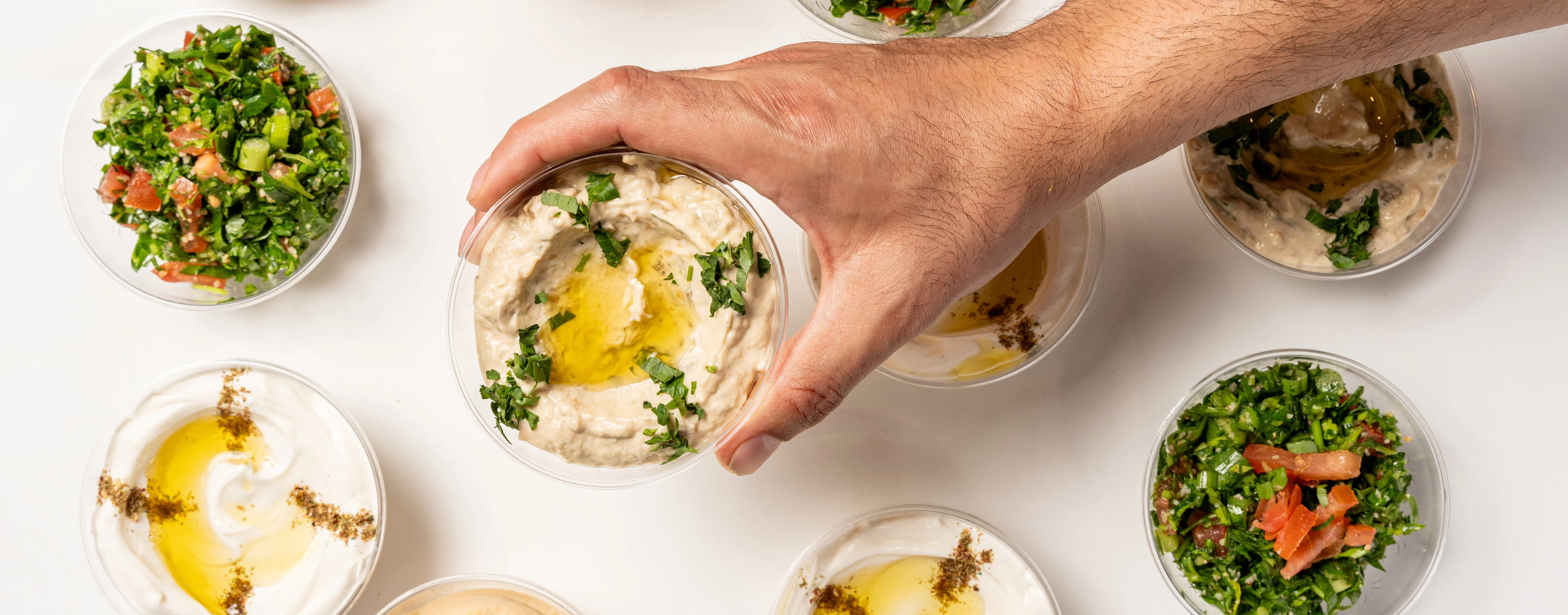 Mediterranean hummus and tabbouleh in clear cups