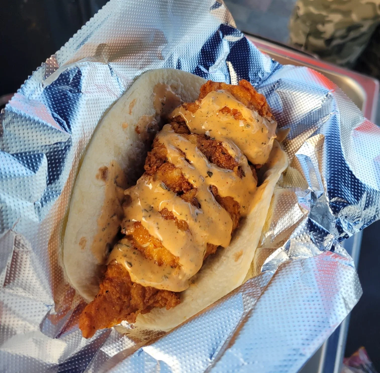 Fish Fried Taco topped by one of  Doz DHR's speciality spicy sauces.