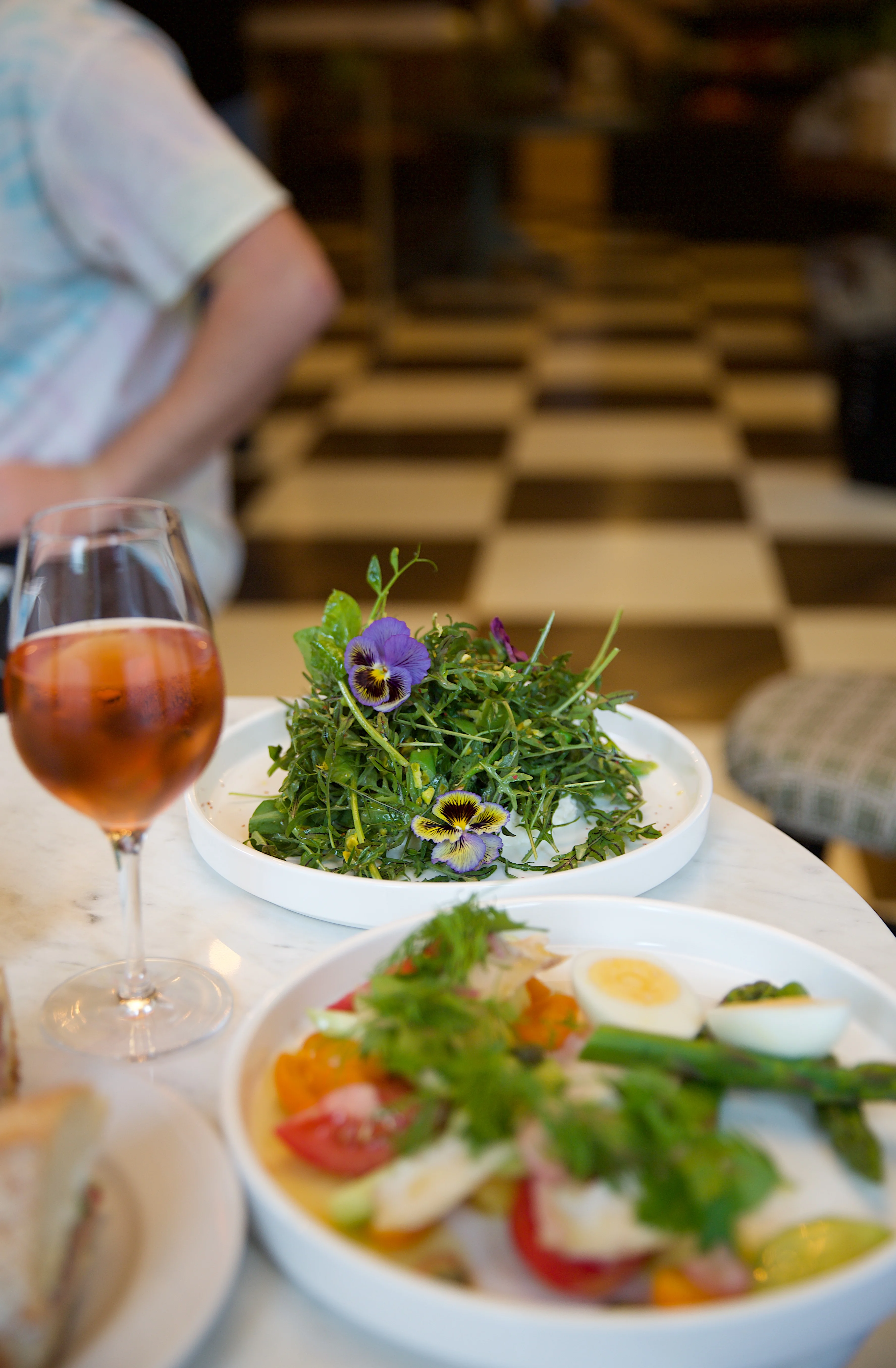Fresh garden salad with edible flowers in a modern dining setting
