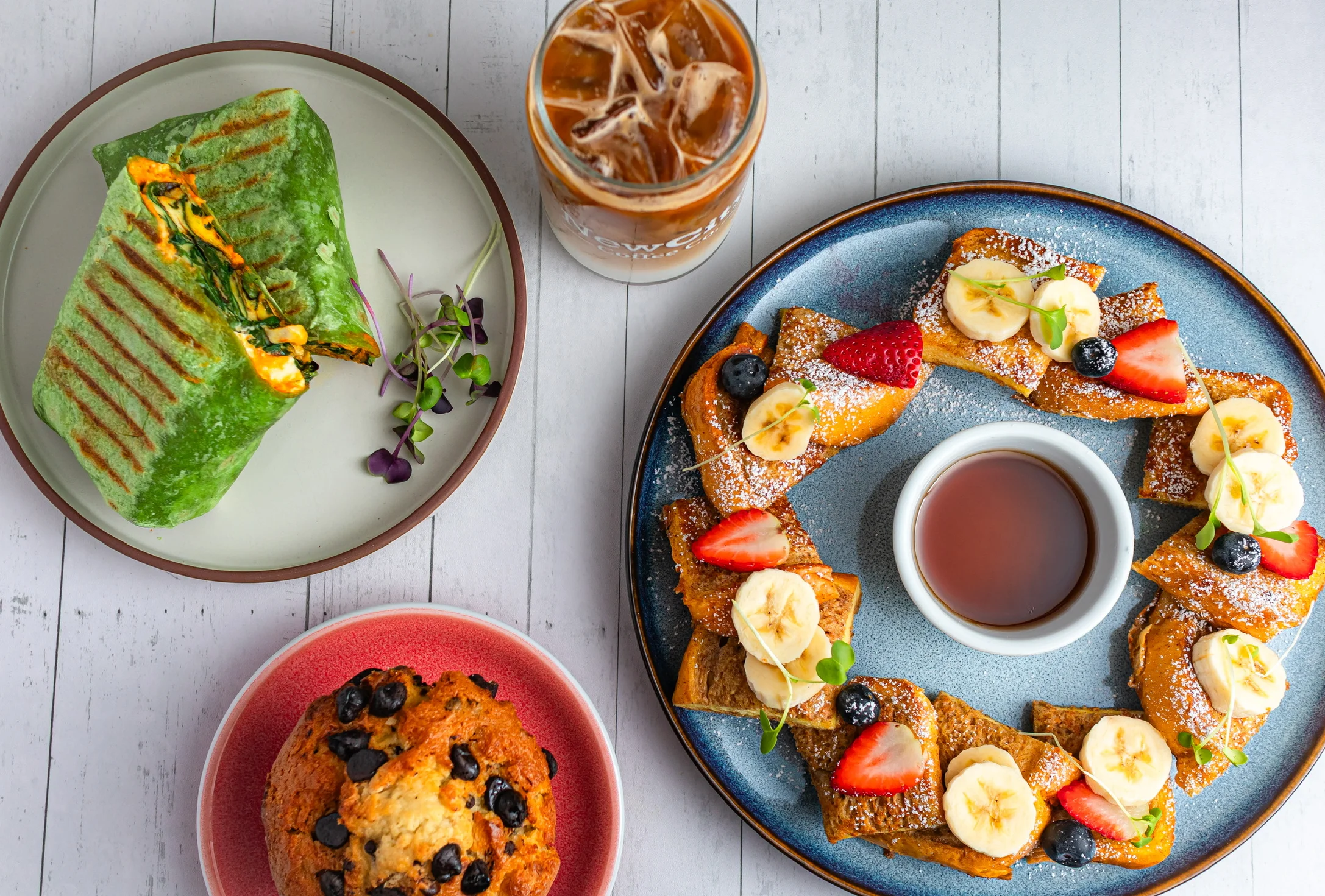 Colorful brunch platter featuring French toast and a spinach wrap