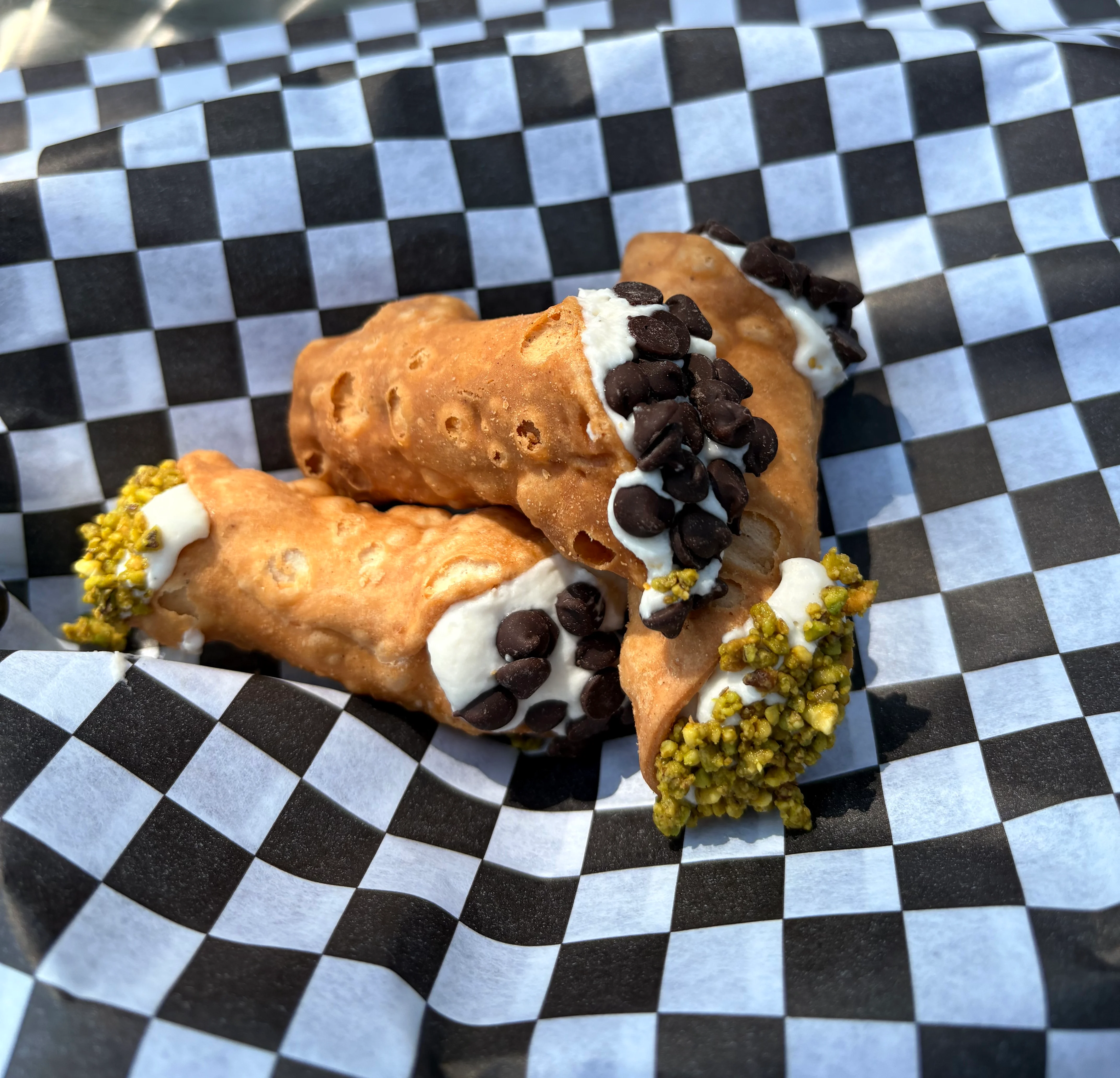 Italian cannoli with chocolate chips and pistachio
