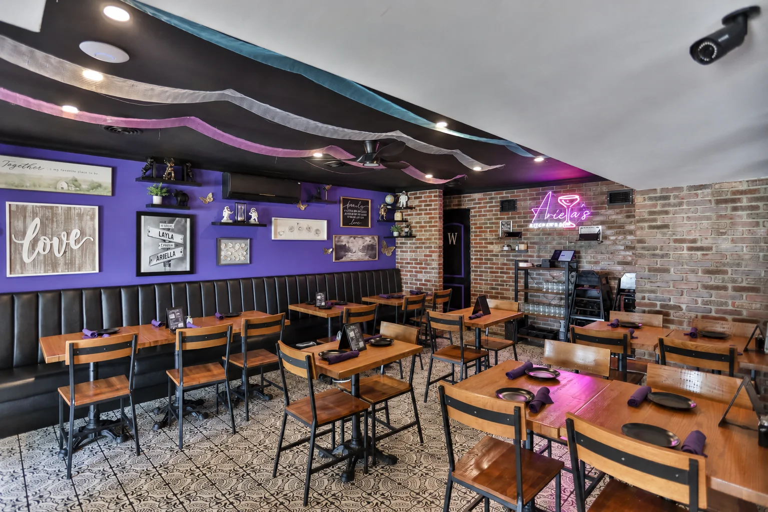 Cozy restaurant interior with purple walls and wooden tables