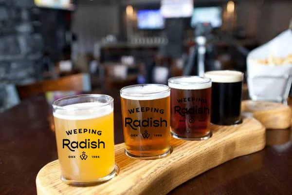 Flight of four Weeping Radish beers on the bar at Firetender in Manteo NC