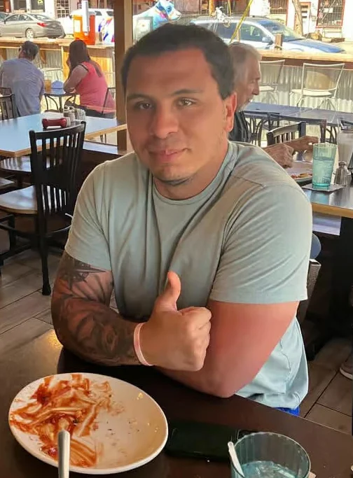 Diner enjoying a plate of pasta in a casual restaurant setting