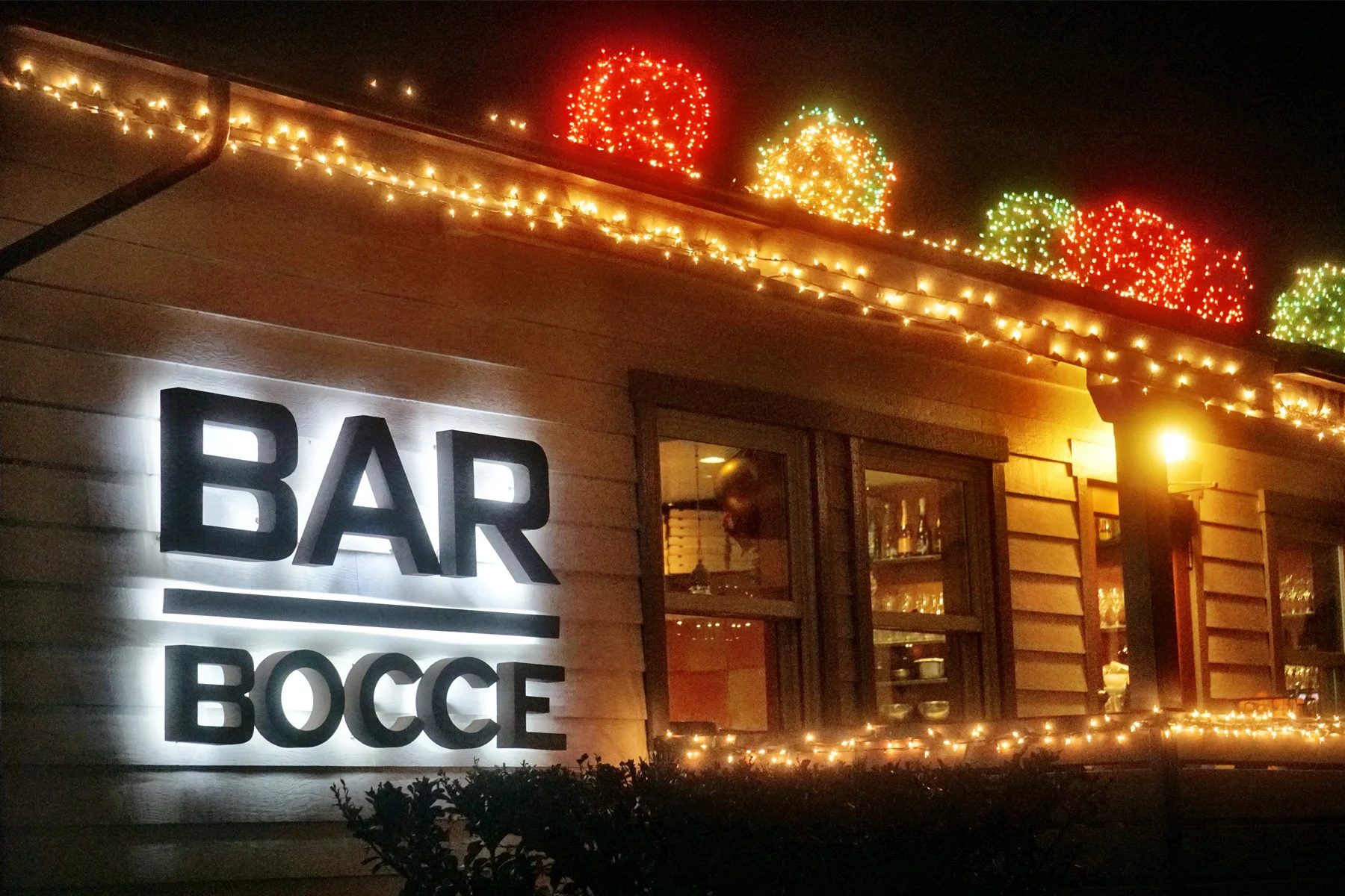Bar Bocce sign with holiday lights around exterior of building