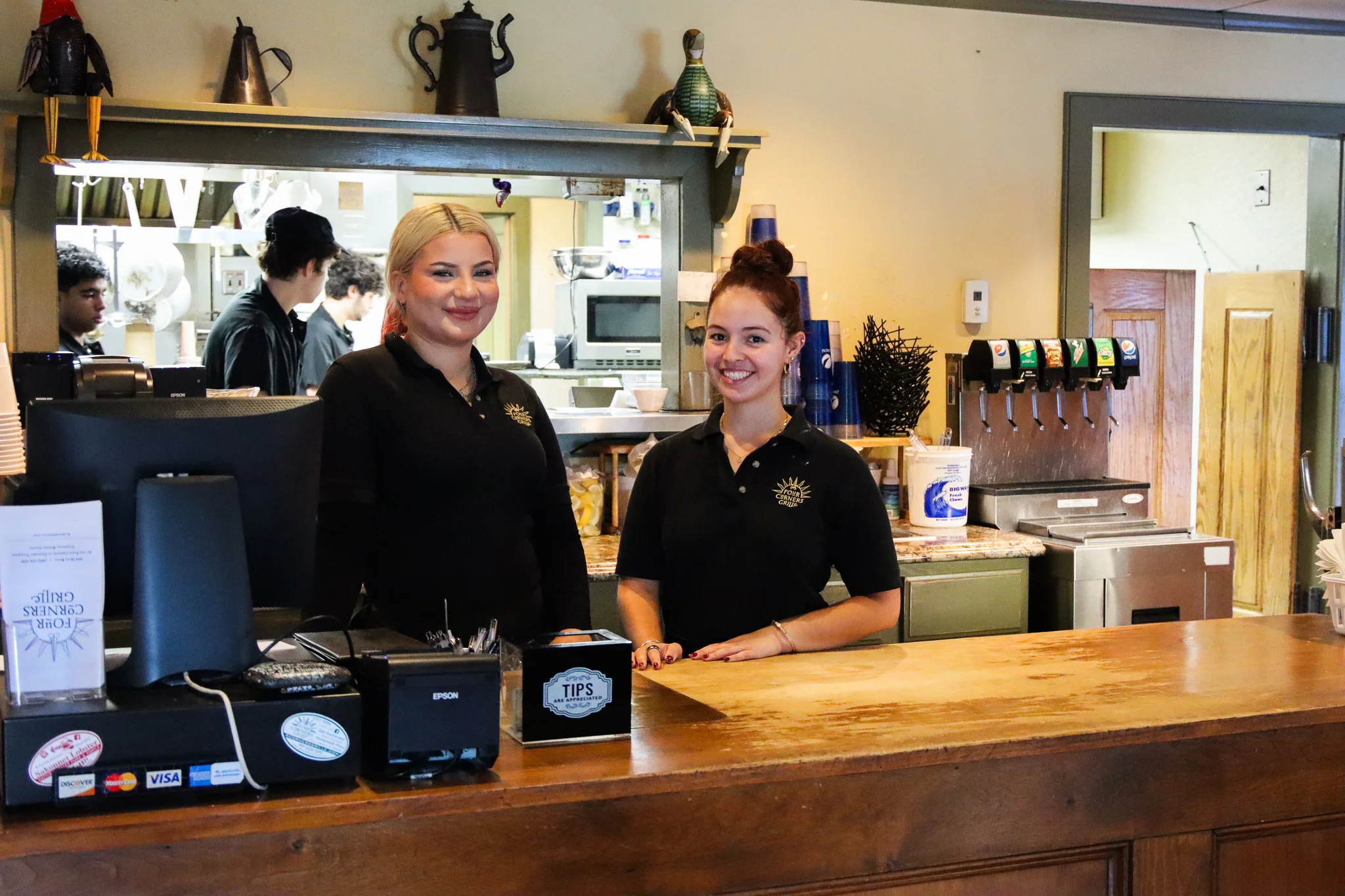 Friendly staff at a cozy restaurant counter