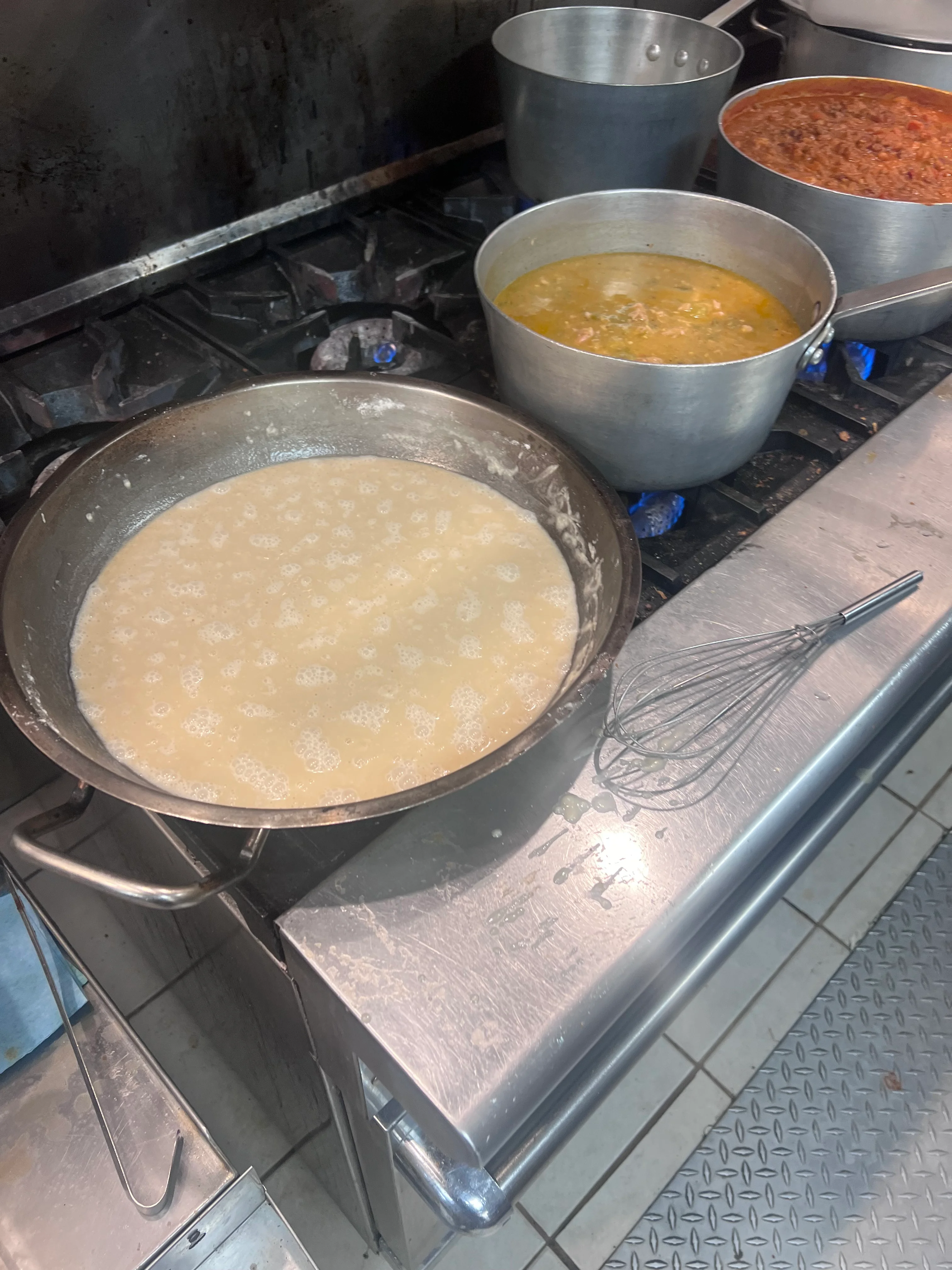 Creamy polenta cooking in a restaurant kitchen