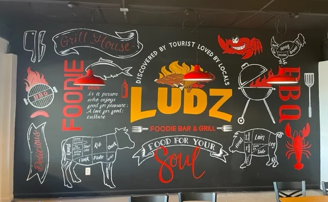 Colorful mural at Ludz Foodie Bar & Grill celebrating food culture