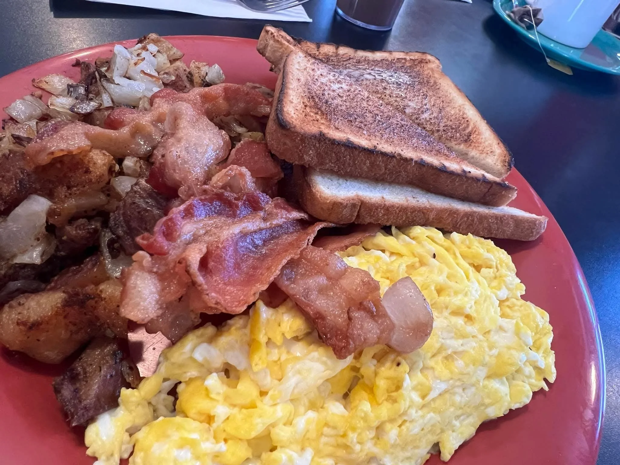 Classic American breakfast platter with eggs, bacon, and toast