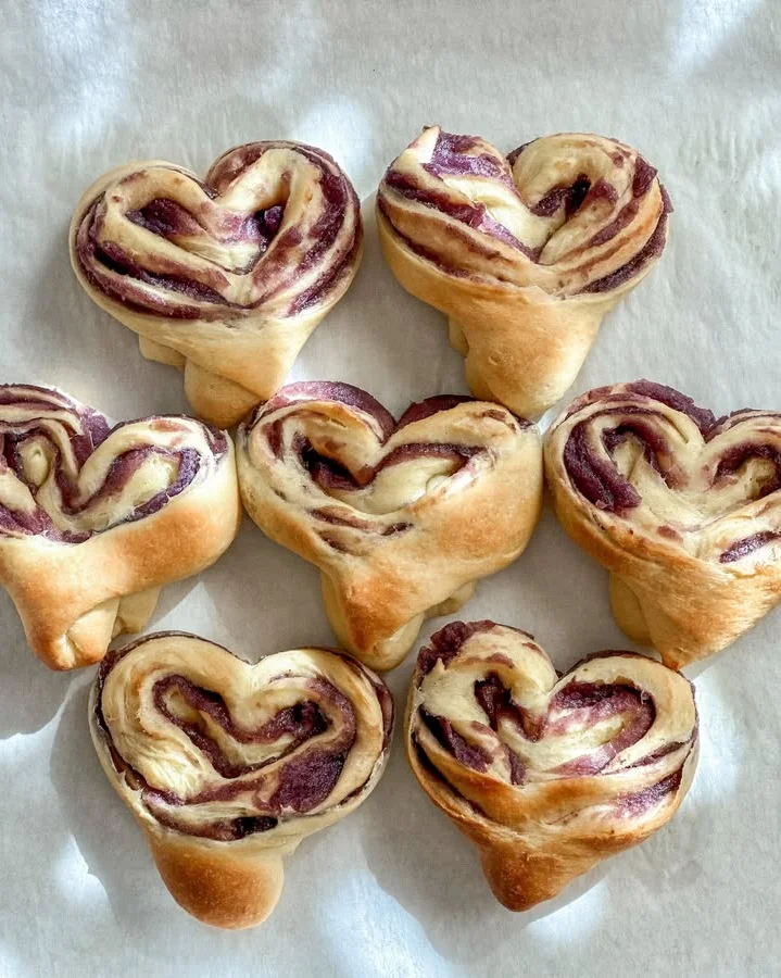 Heart-shaped chocolate swirl pastries on parchment paper