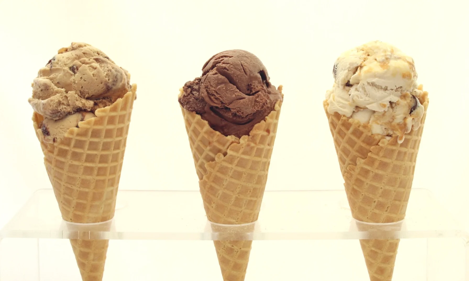 Three ice cream cones with different flavors