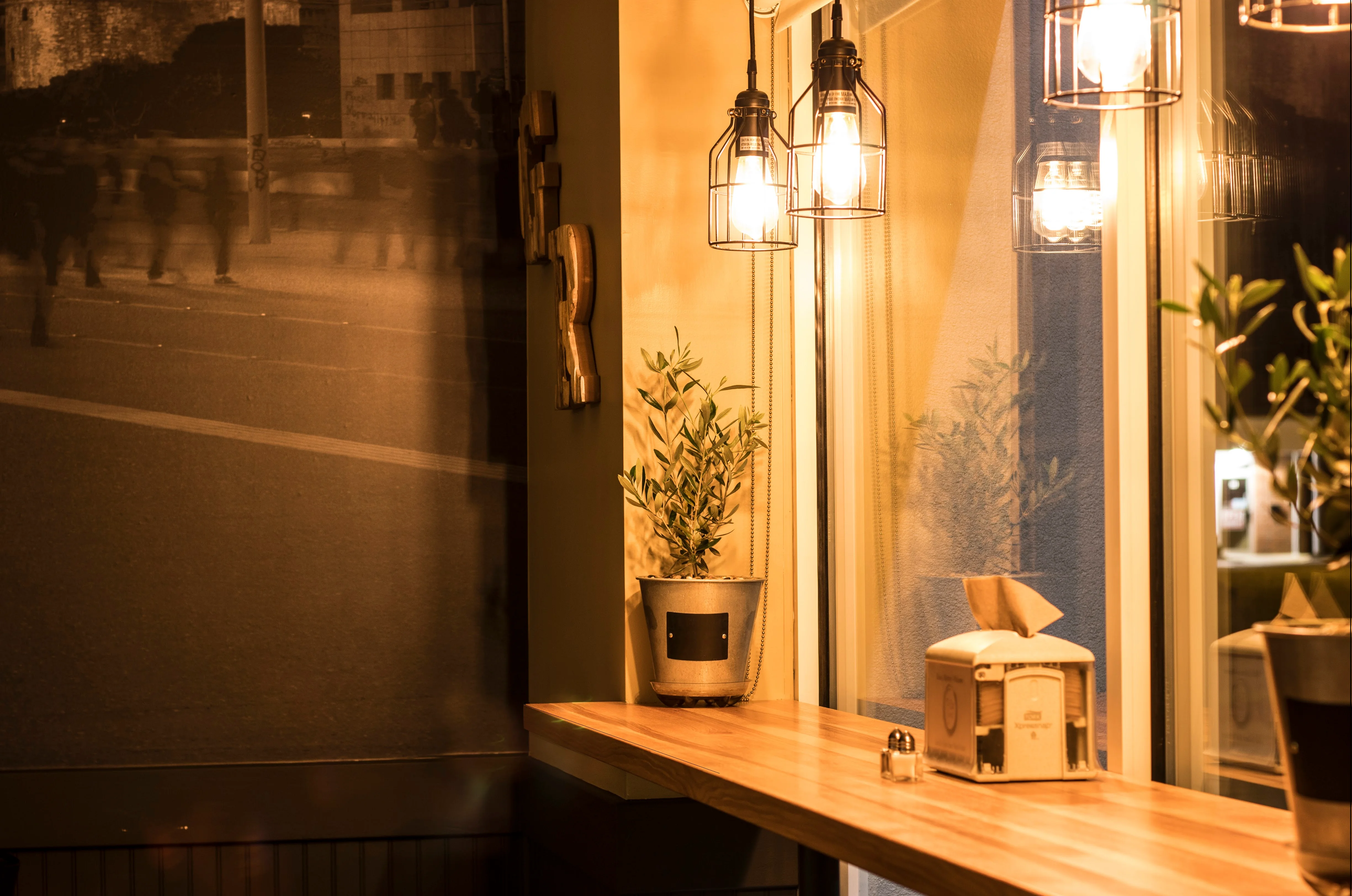 Cozy restaurant interior with warm lighting and plants