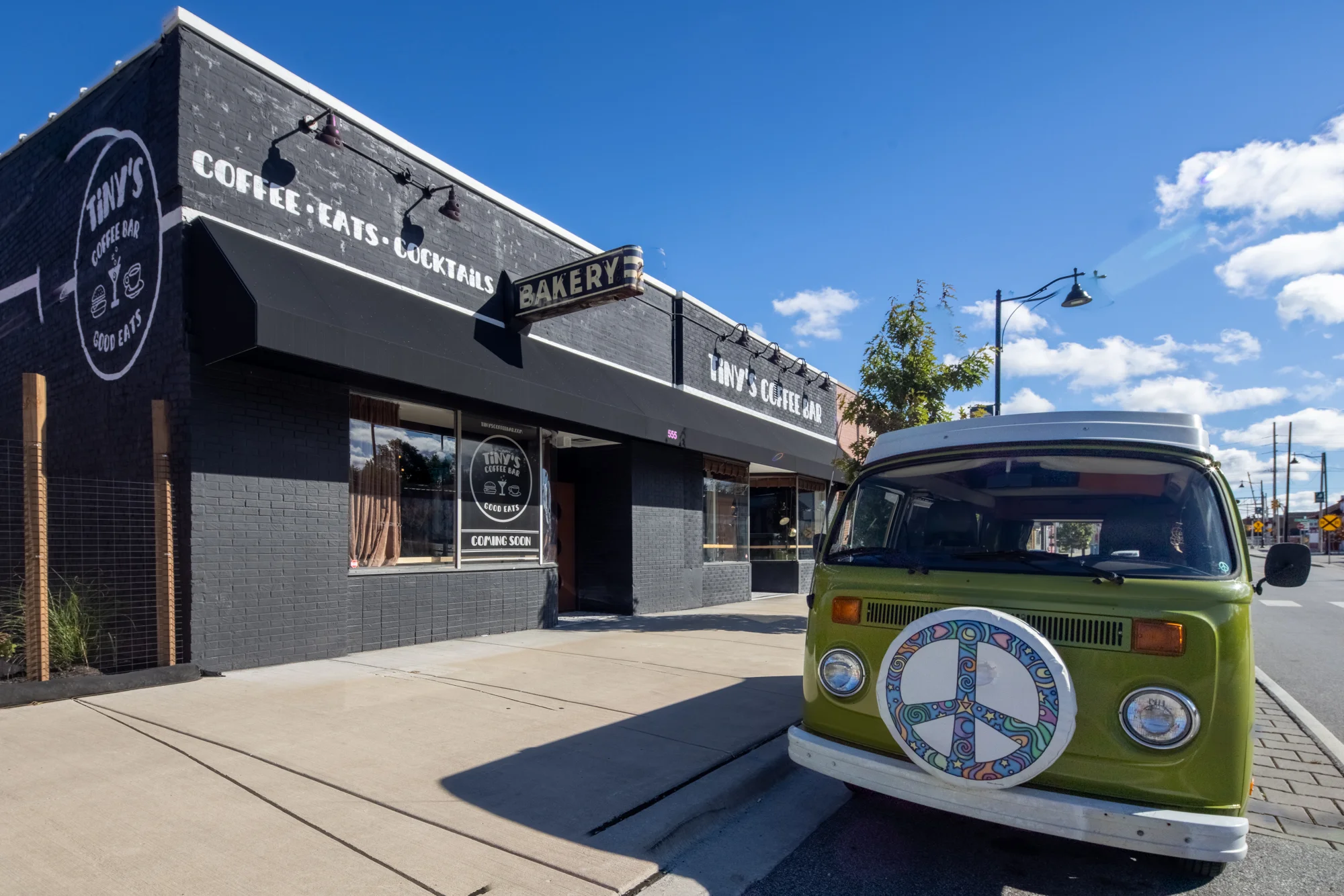 Exterior of Tiny's Coffee Bar with a vintage van