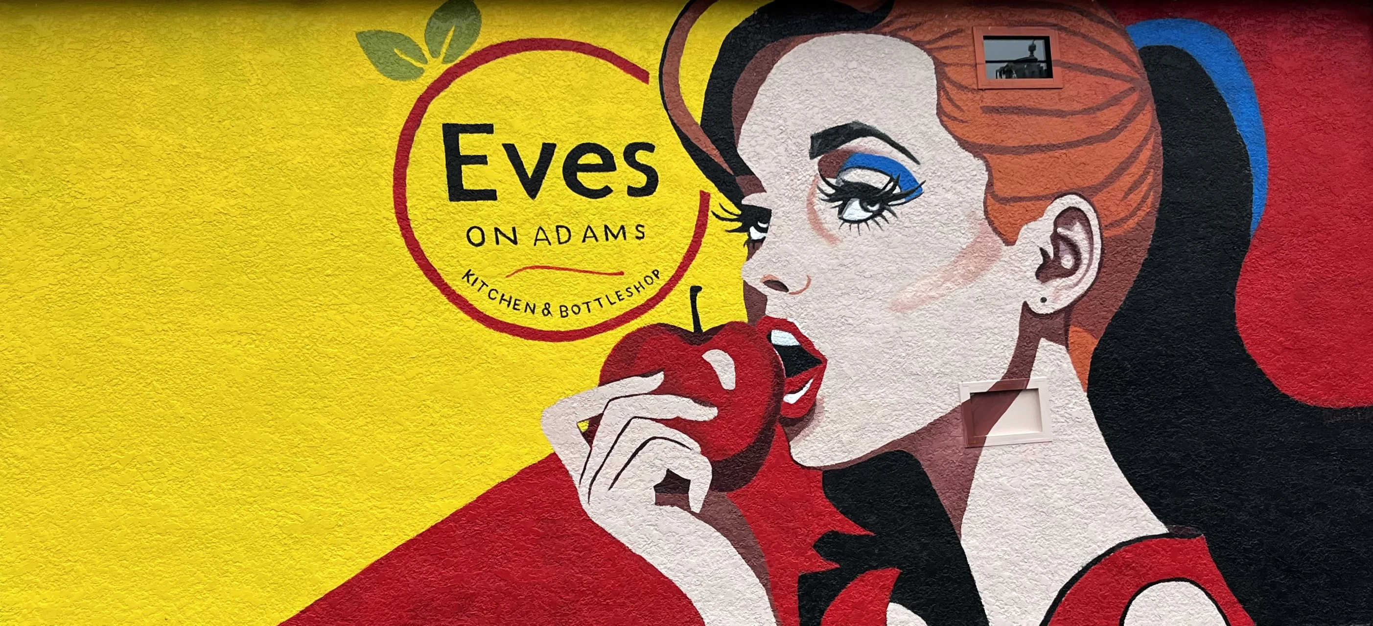 Eves on Adams mural of woman with apple