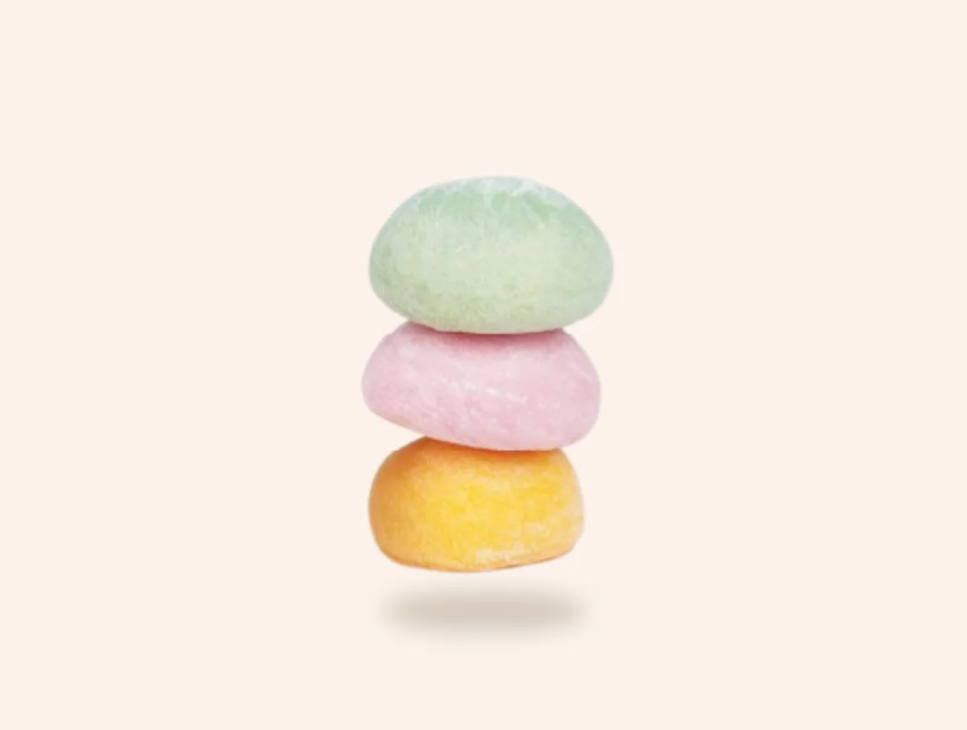 Stack of colorful Japanese mochi sweets on a white background