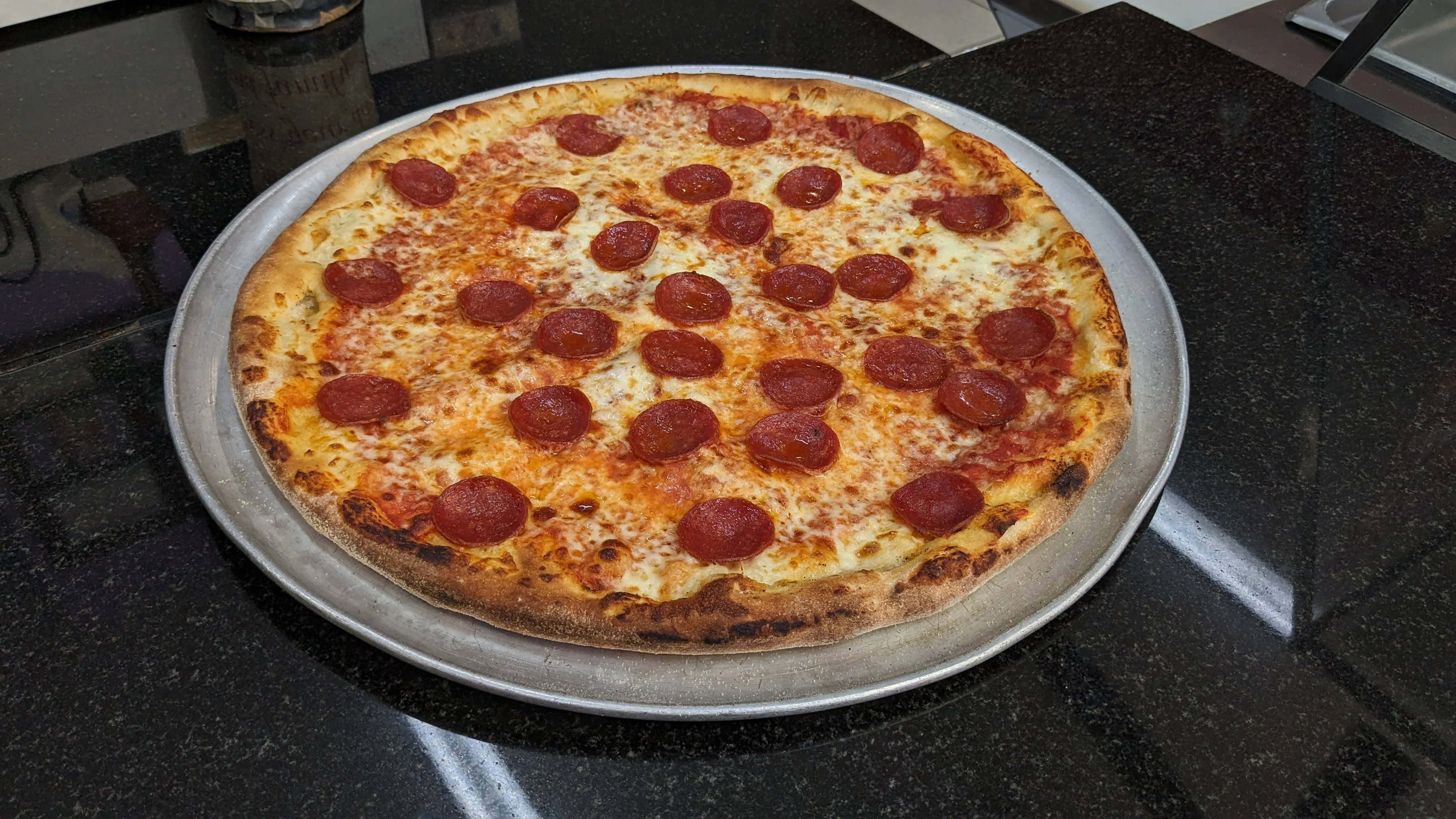 Classic pepperoni pizza on a silver platter