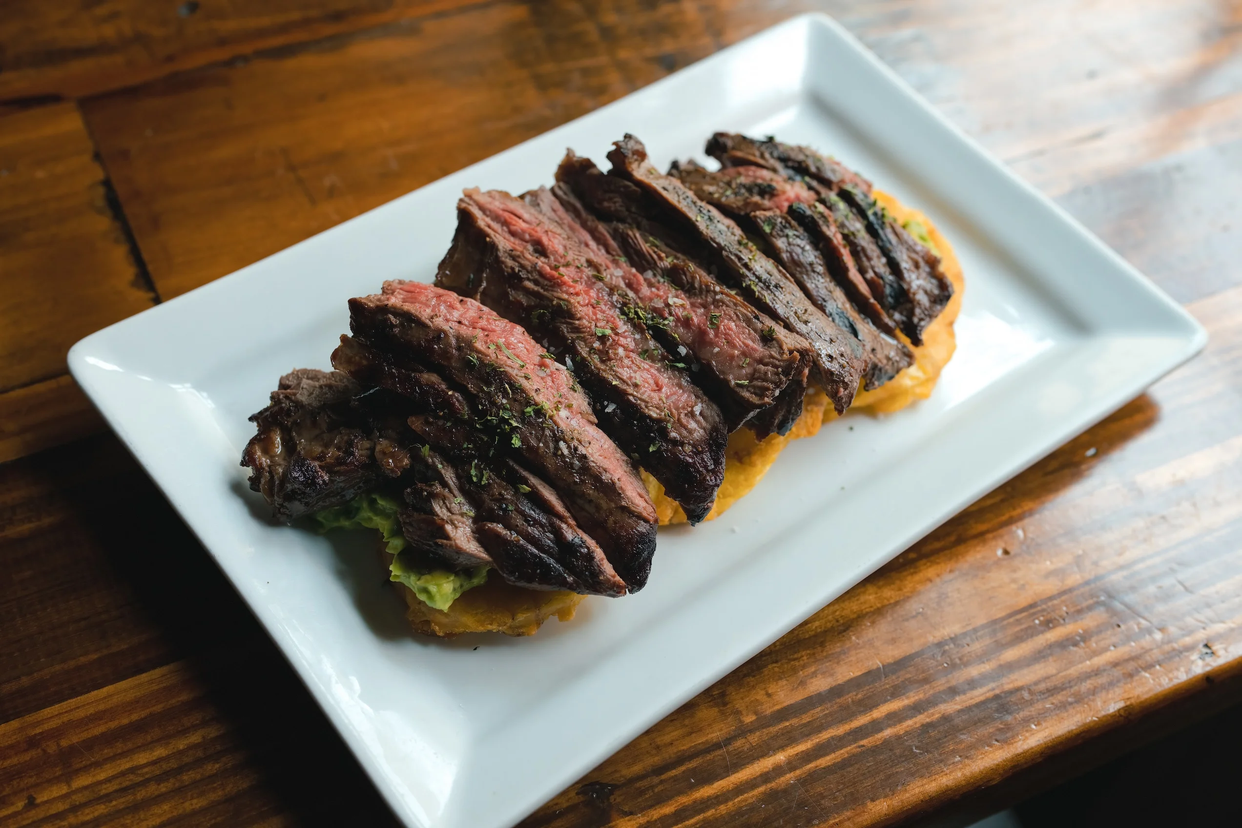 Grilled flank steak served on a plate