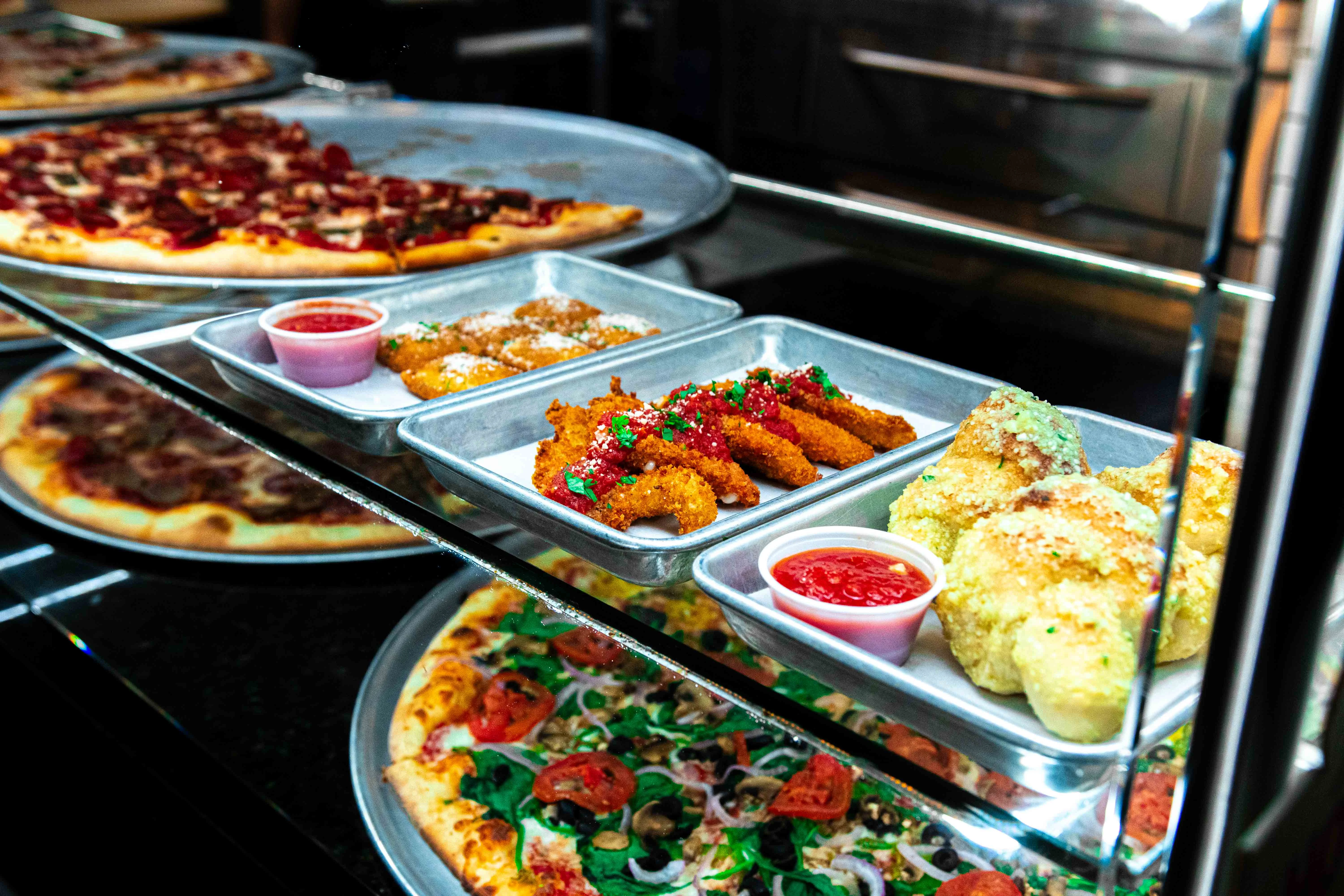 Assorted Italian appetizers with pizza in a vibrant restaurant display
