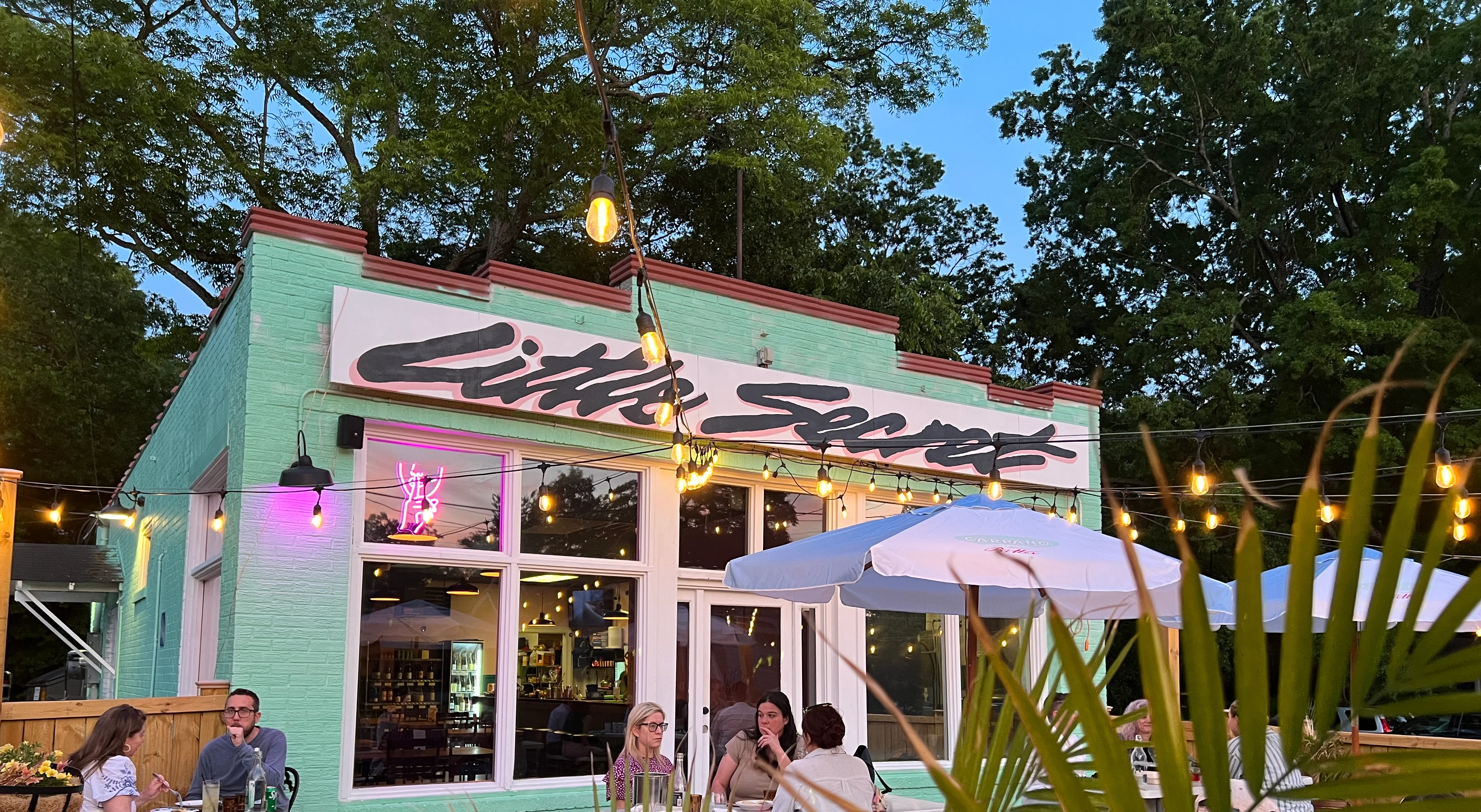 Charming restaurant exterior with outdoor seating and string lights