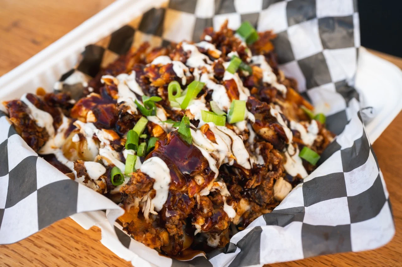 BBQ chicken nachos topped with sauce and green onions