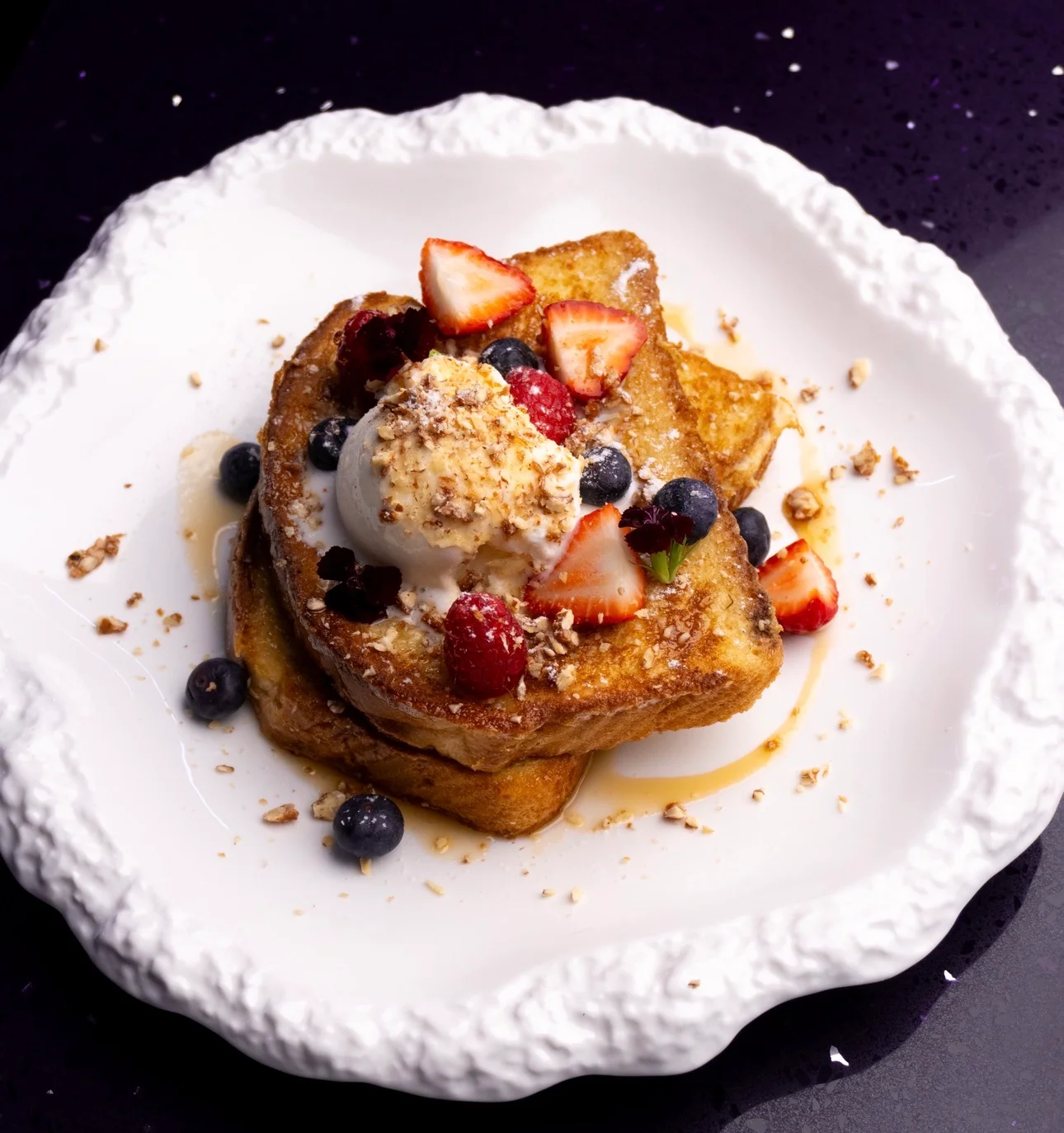 French toast topped with berries and ice cream