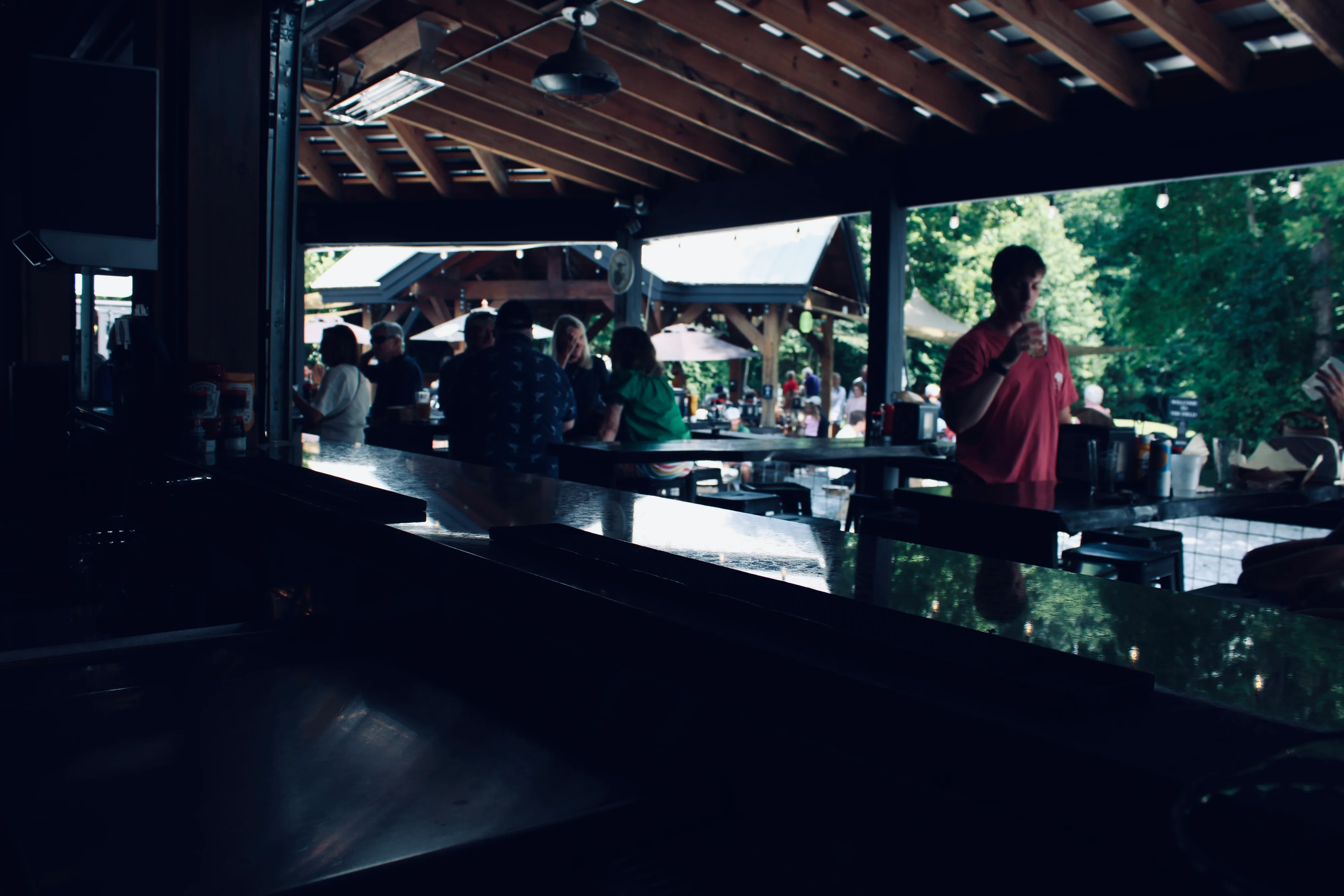 Lively outdoor bar scene with patrons enjoying drinks