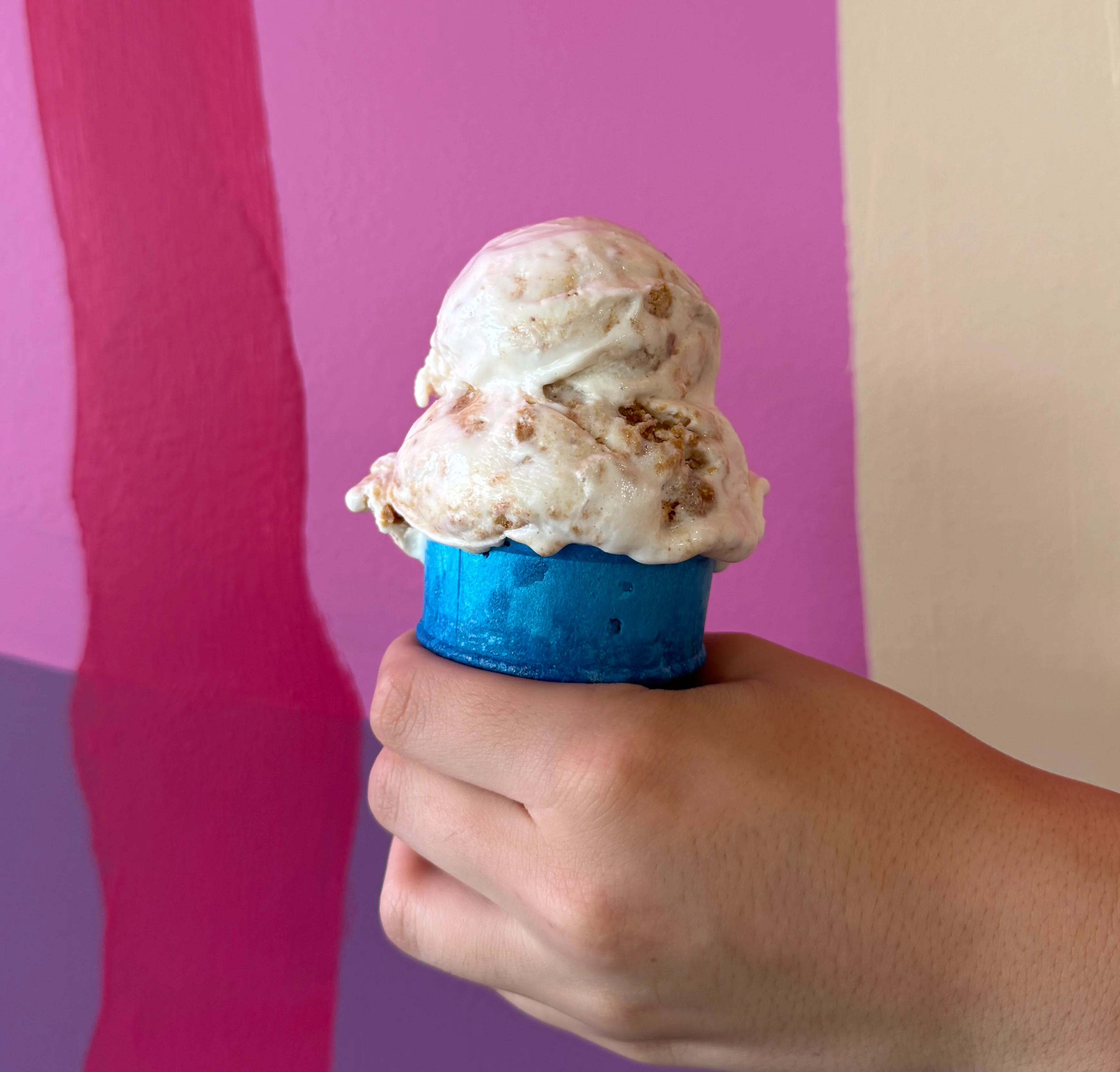 Scoop of vanilla ice cream in a colorful cup