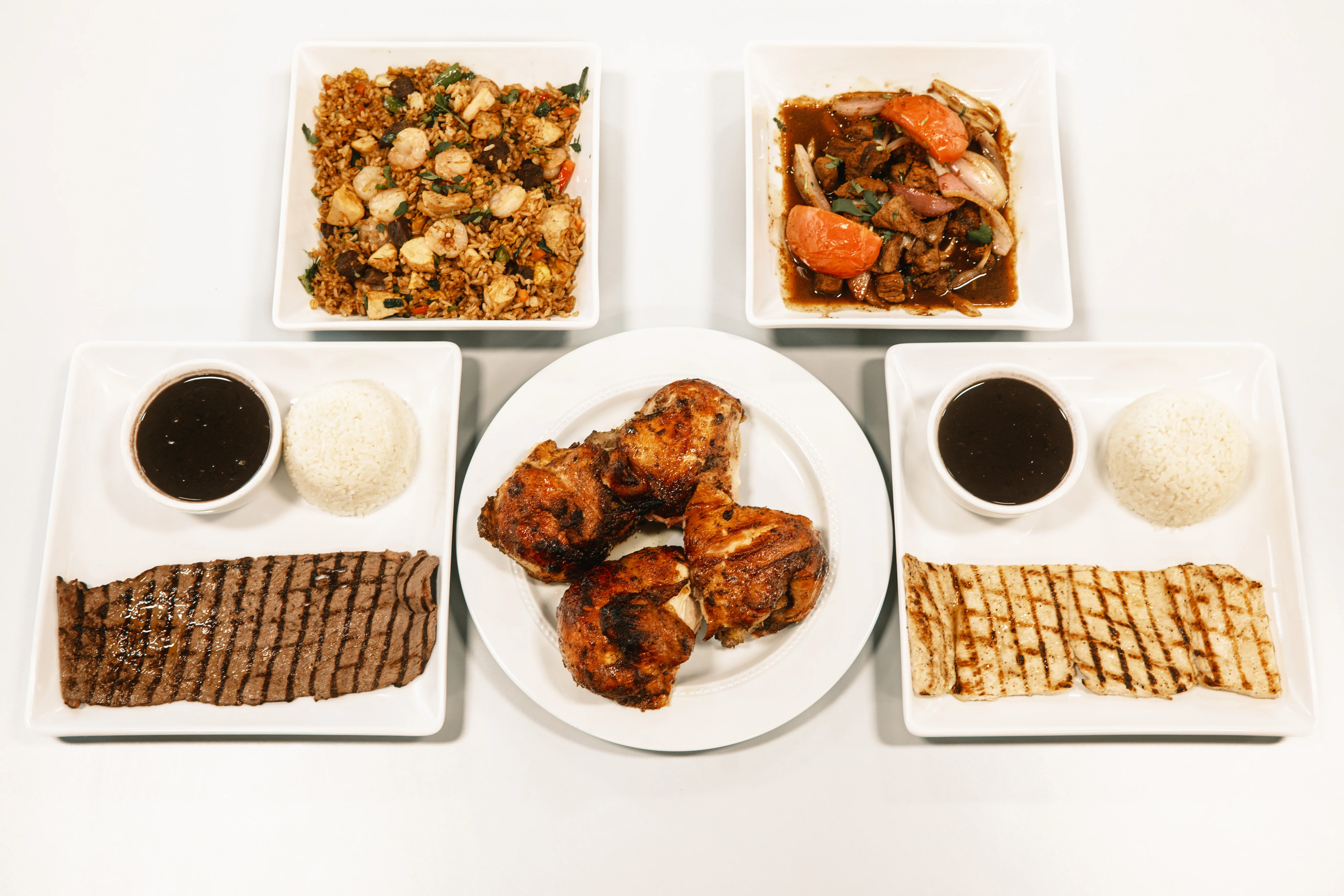 Assorted Asian dishes including fried rice and grilled chicken