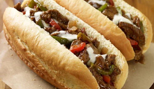Philly cheesesteak sandwiches with peppers and onions