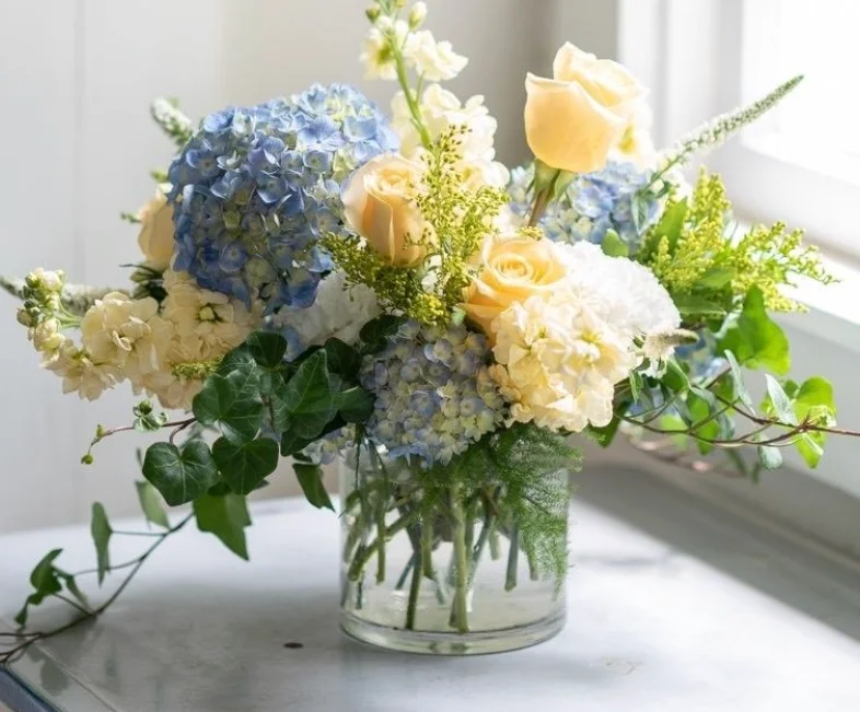 Elegant floral arrangement with blue and yellow flowers