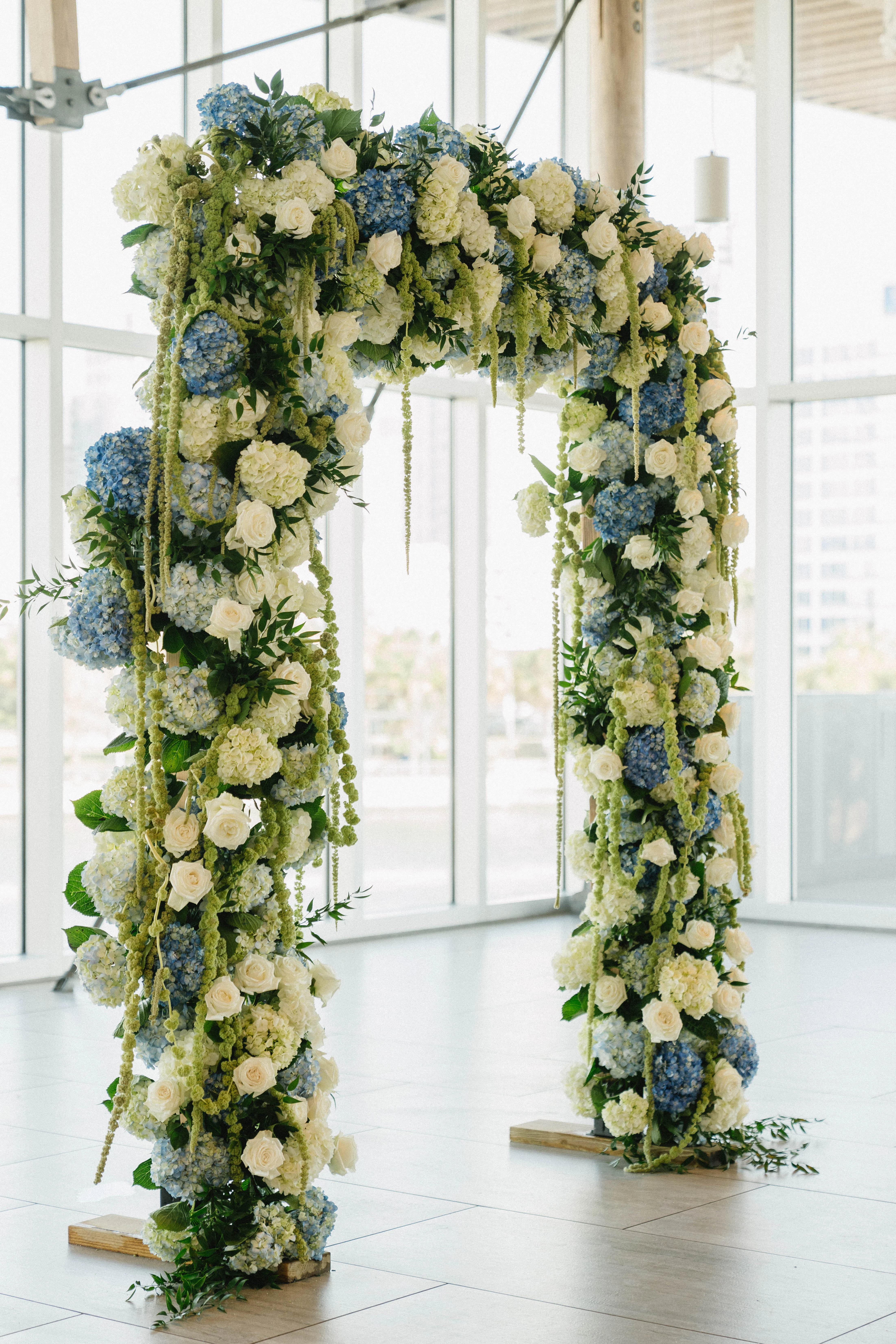 Elegant floral arch with blue and white flowers for a wedding ceremony